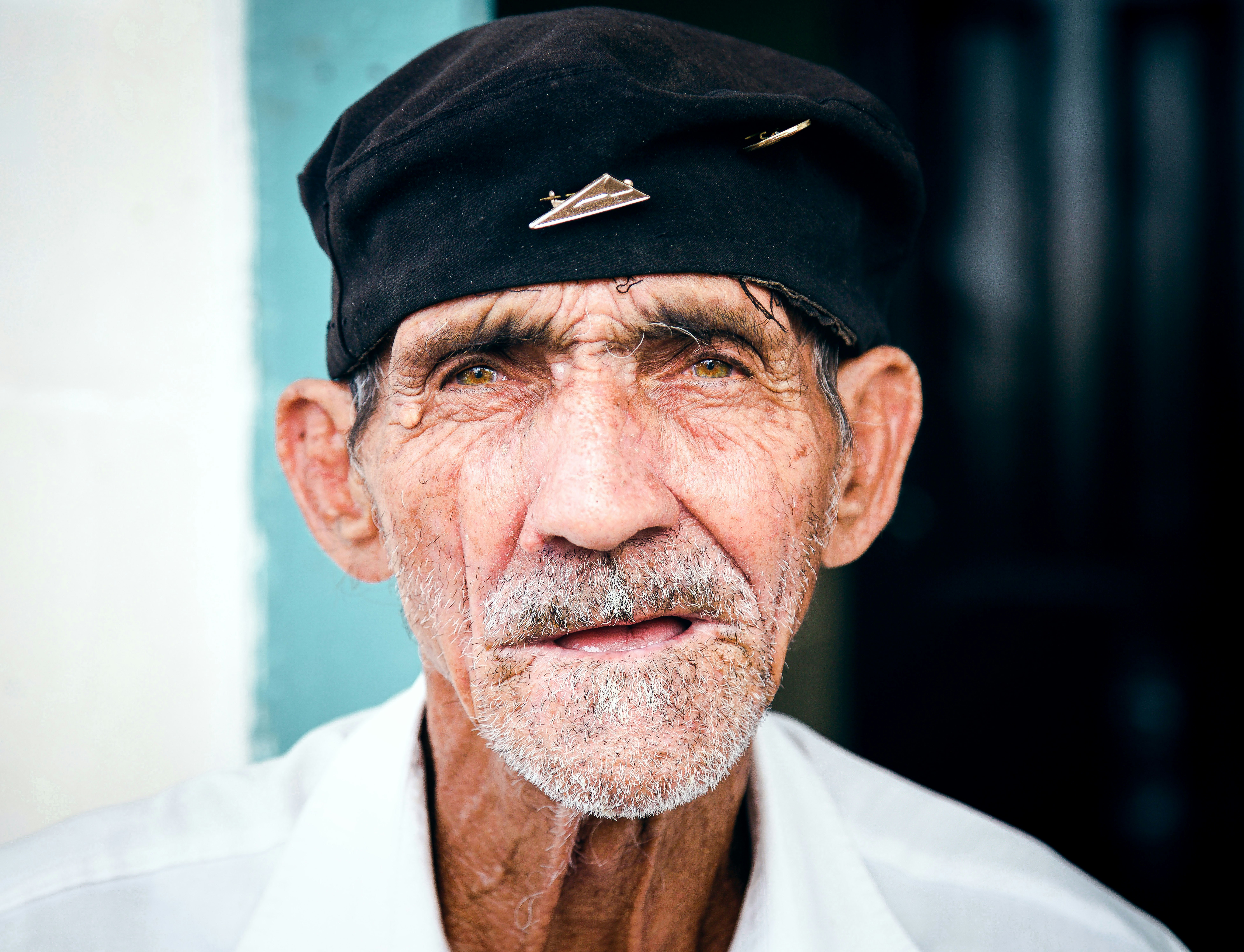 An elderly man wearing a black beret