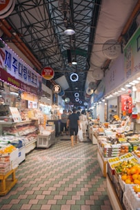Busy indoor market with food stalls and shoppers