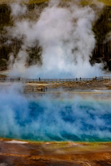Geothermal hot spring with steam and colorful mineral deposits