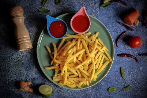 French fries with ketchup and a lime wedge of lime