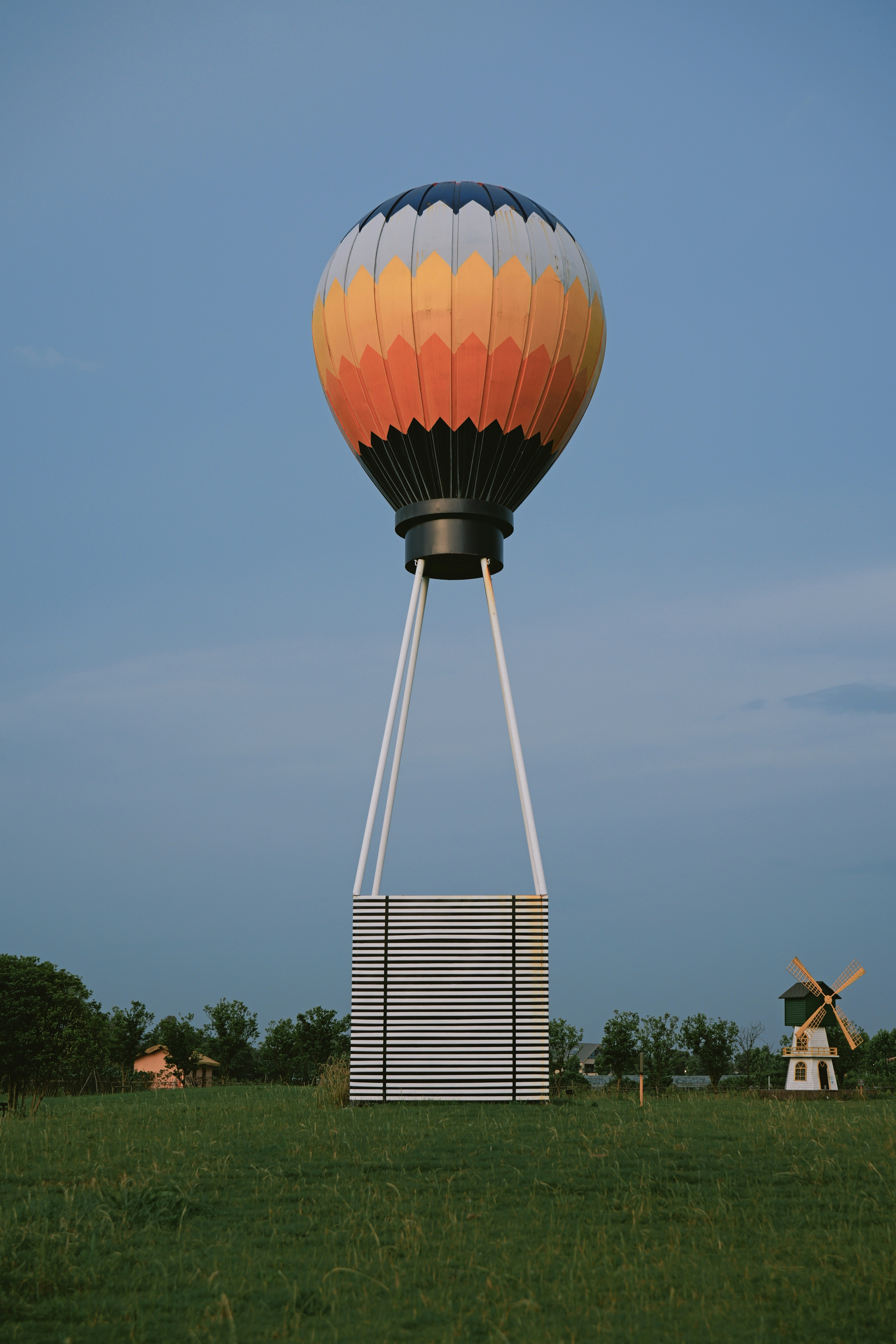 Hot air balloon with a basket over green field