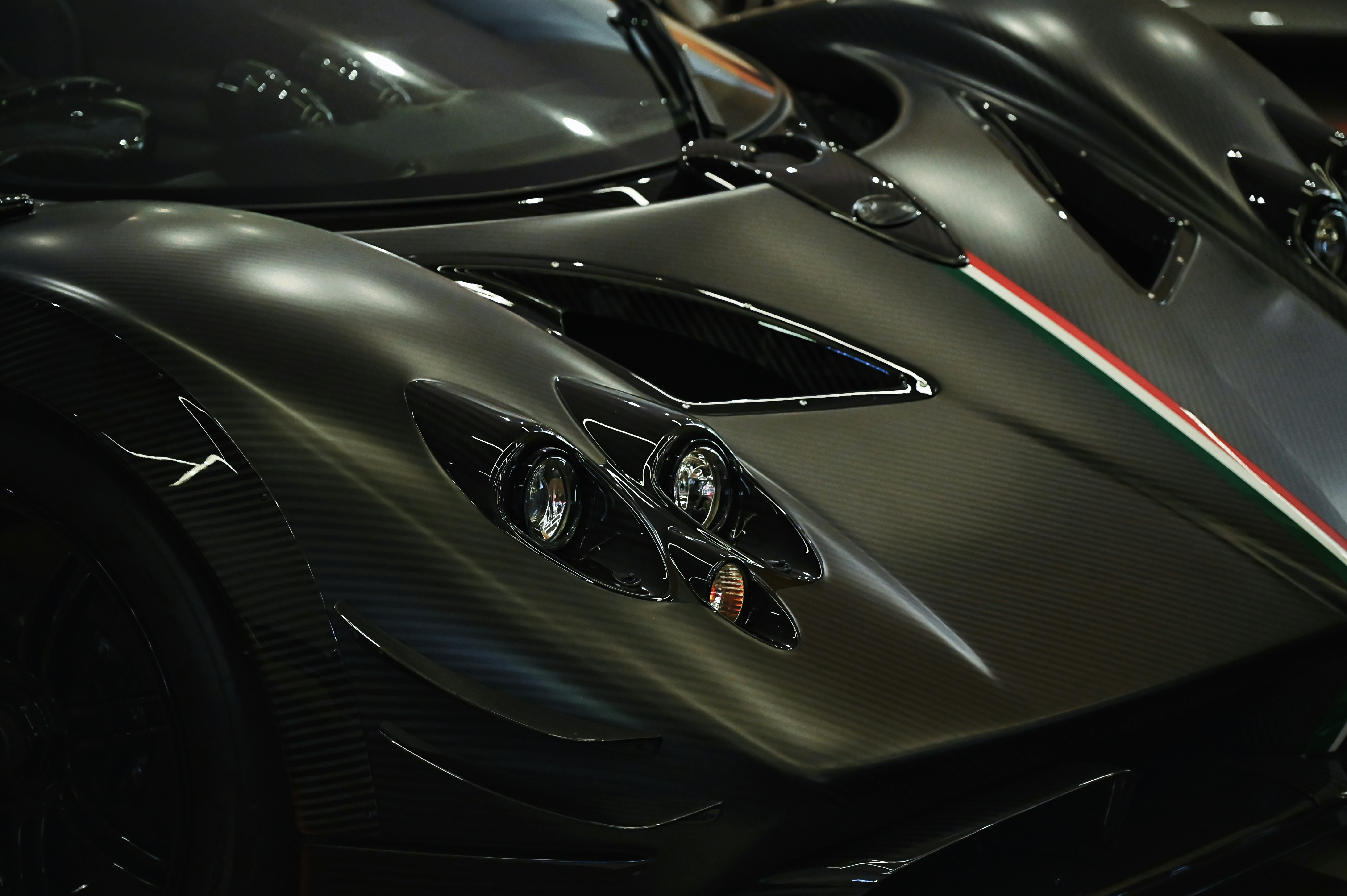 Close-up of a sleek, dark grey sports car.