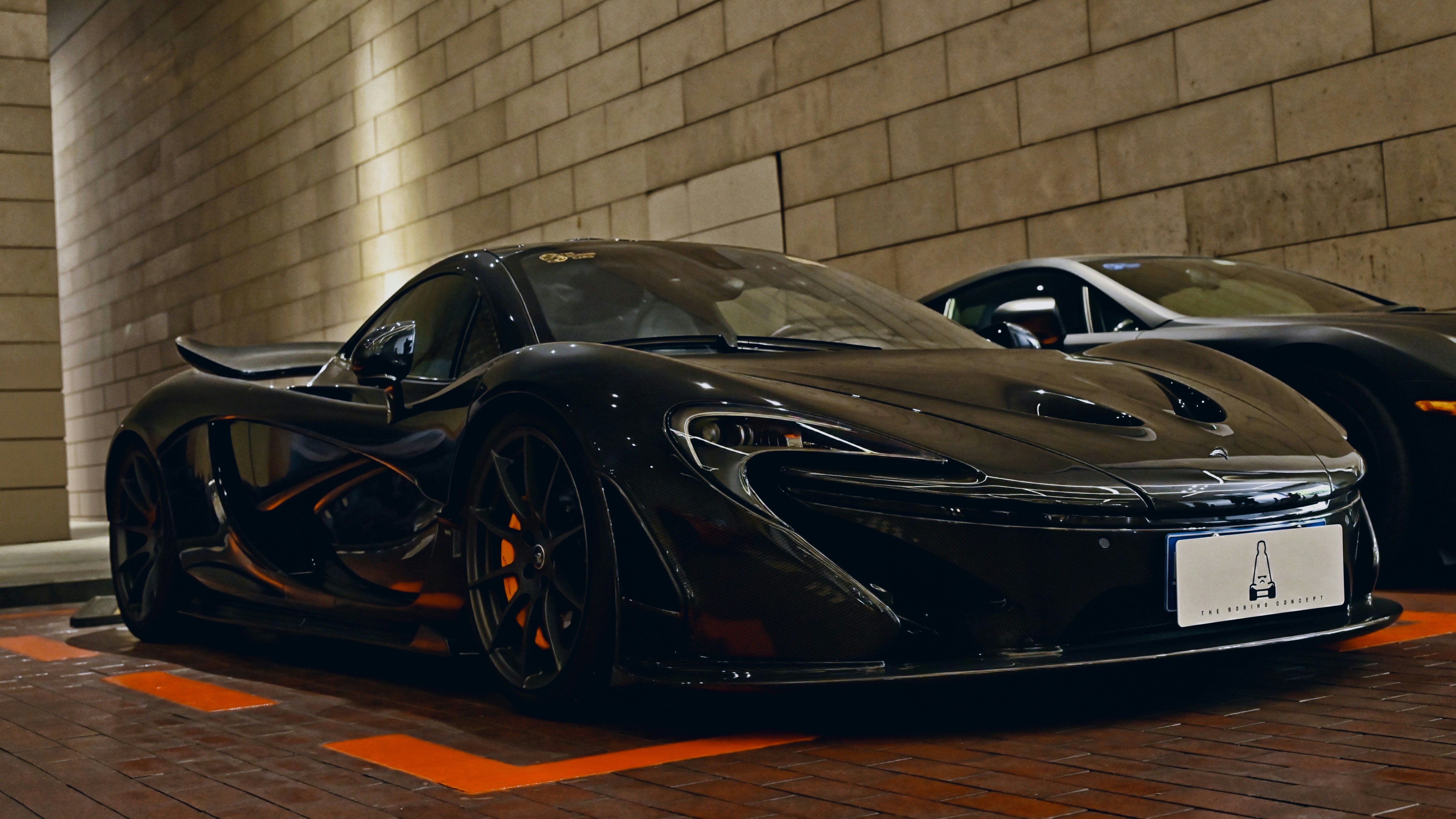 A sleek black mclaren p1 parked indoors.