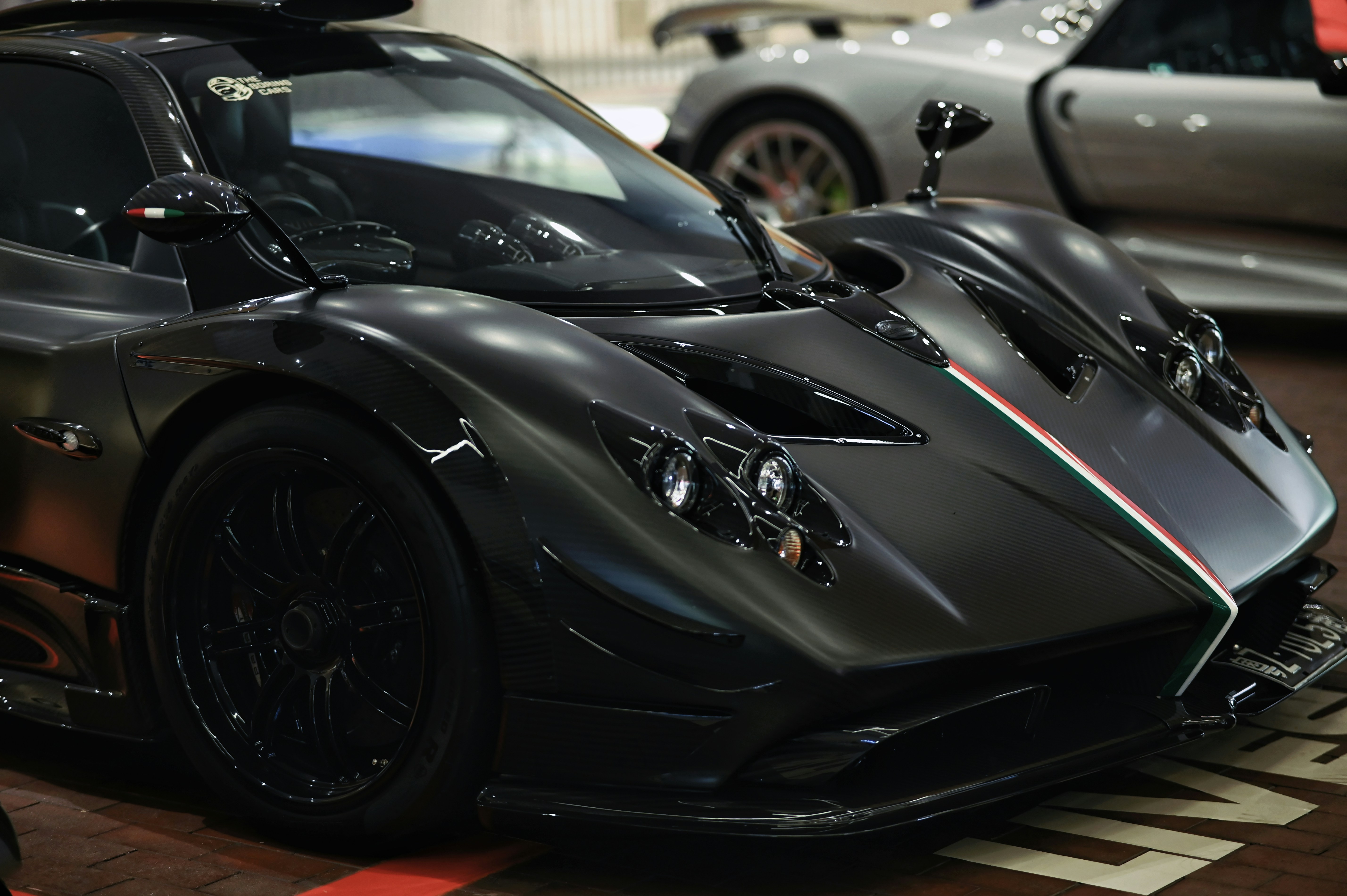 Sleek black sports car with intricate design details.