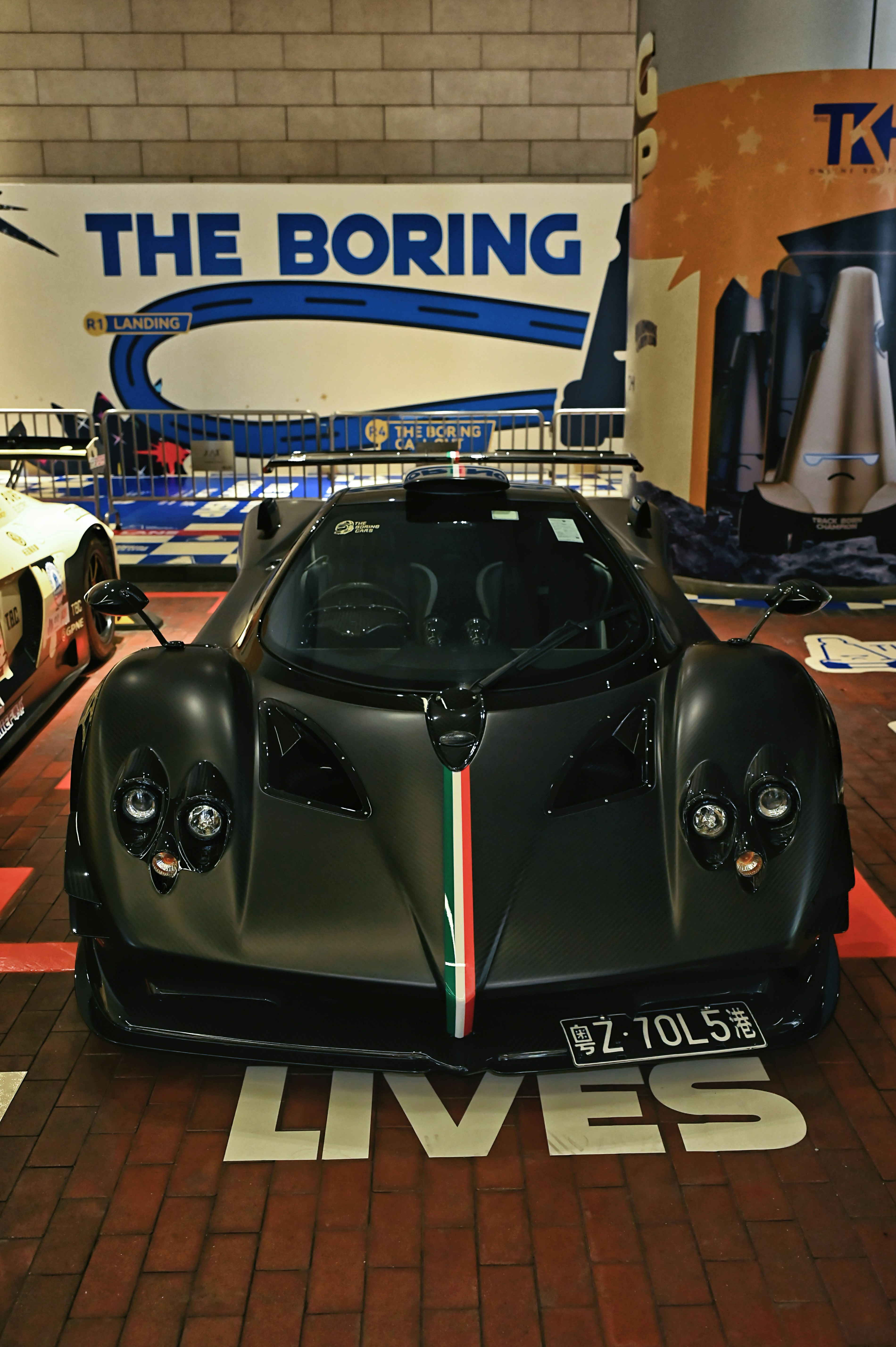 A sleek black sports car with italian flag colors.