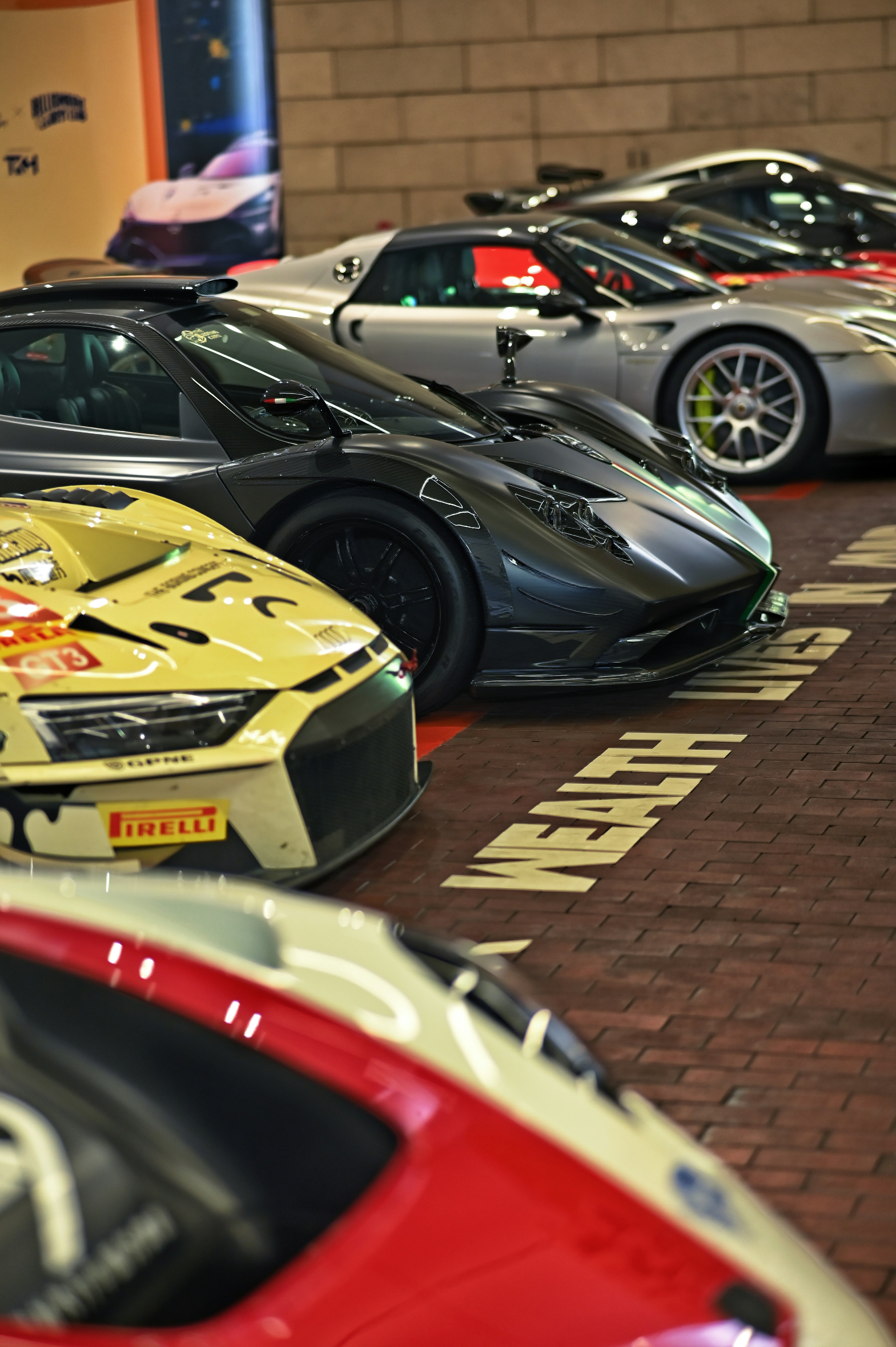 Several luxury sports cars parked in a row.
