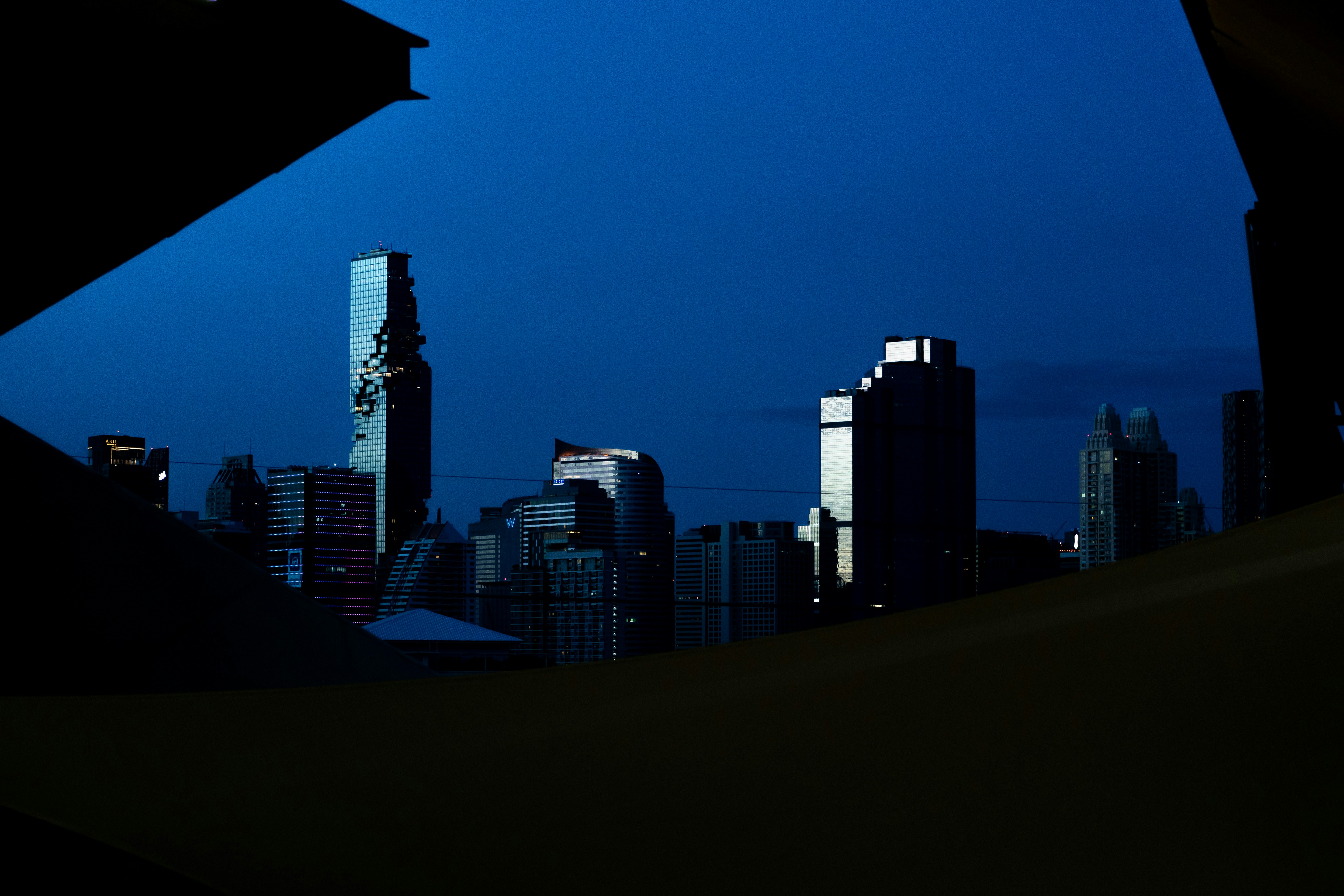City skyline at dusk with dark blue sky.
