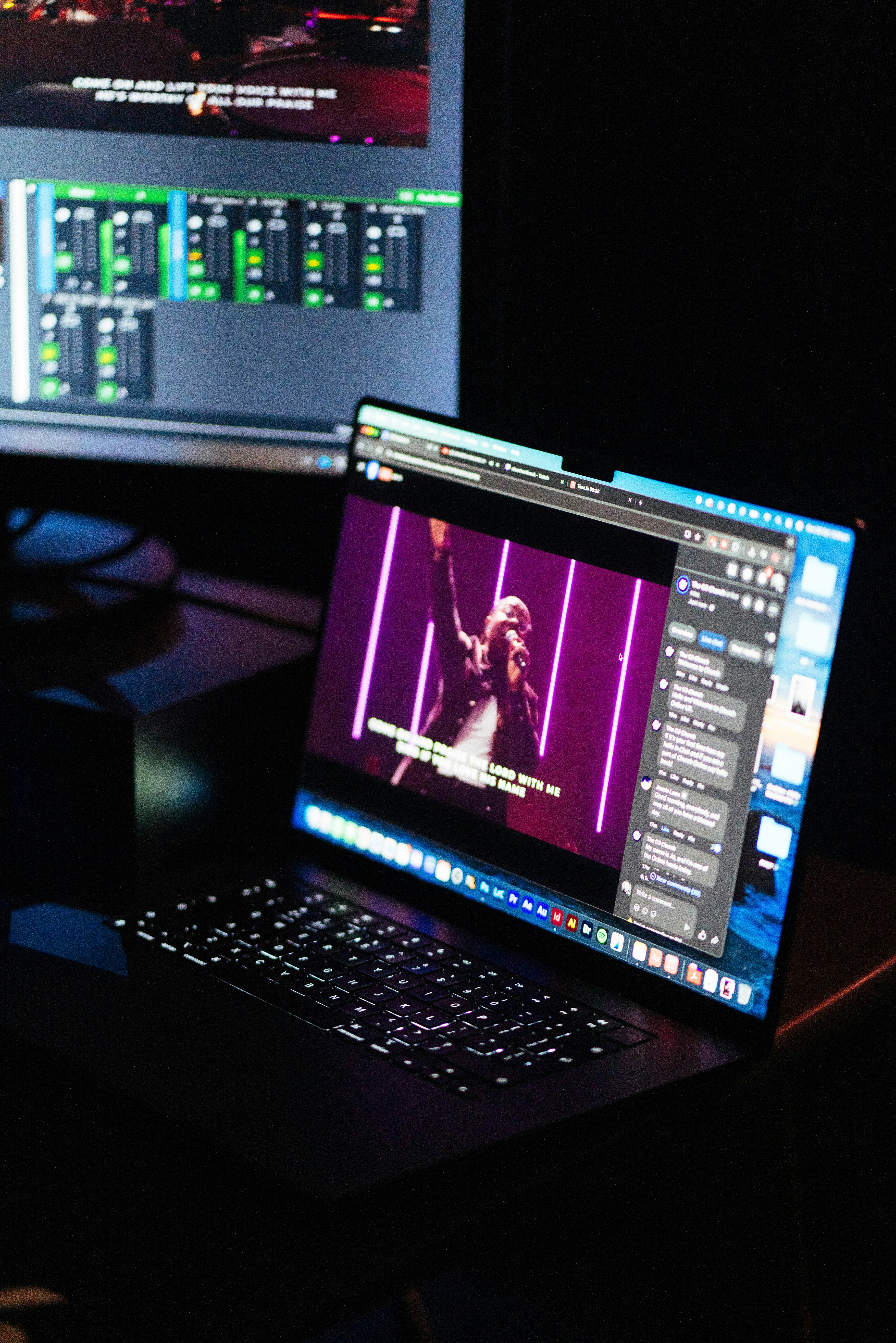 Laptop displaying video with purple background lights.