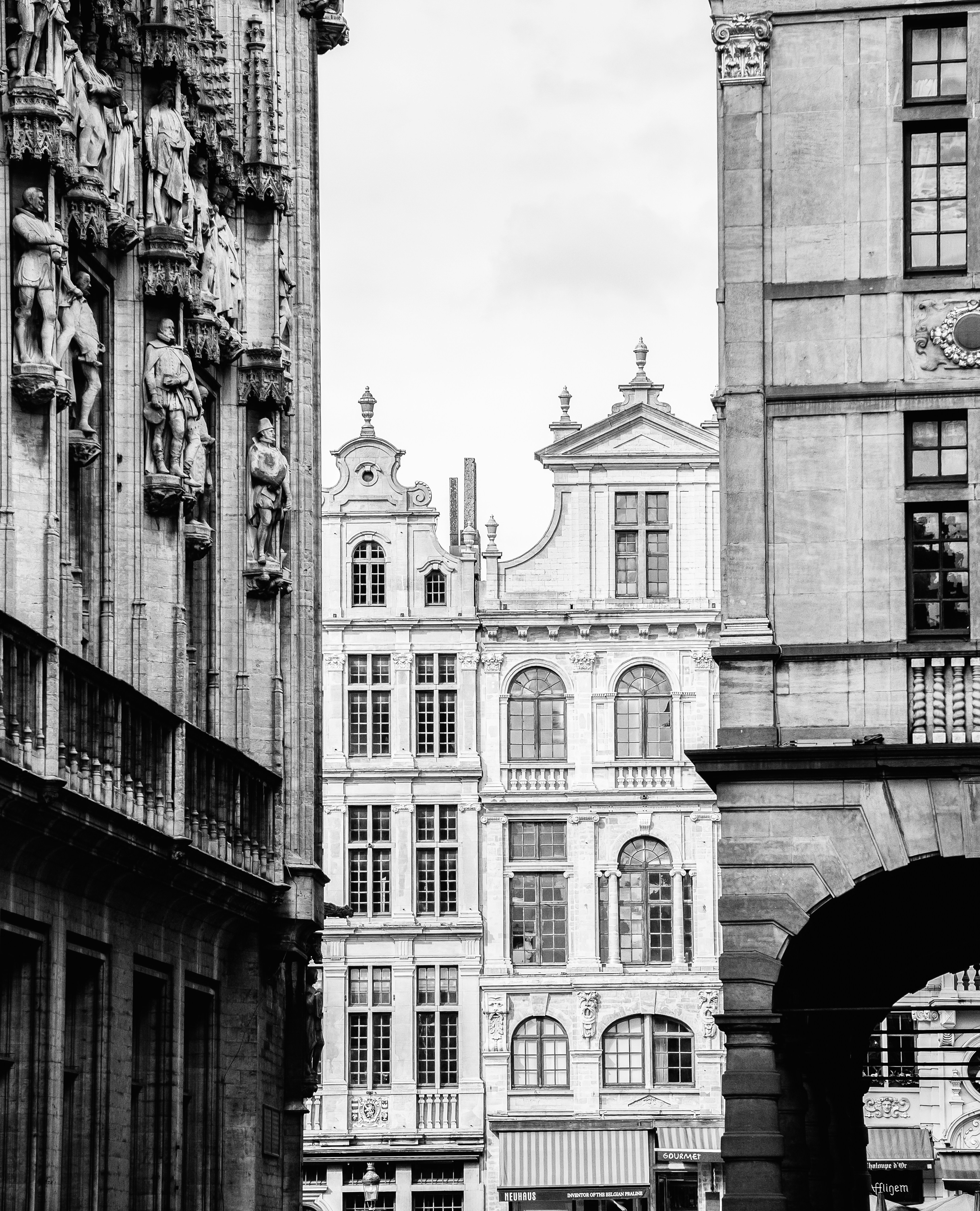 Ornate historic buildings line a european street.