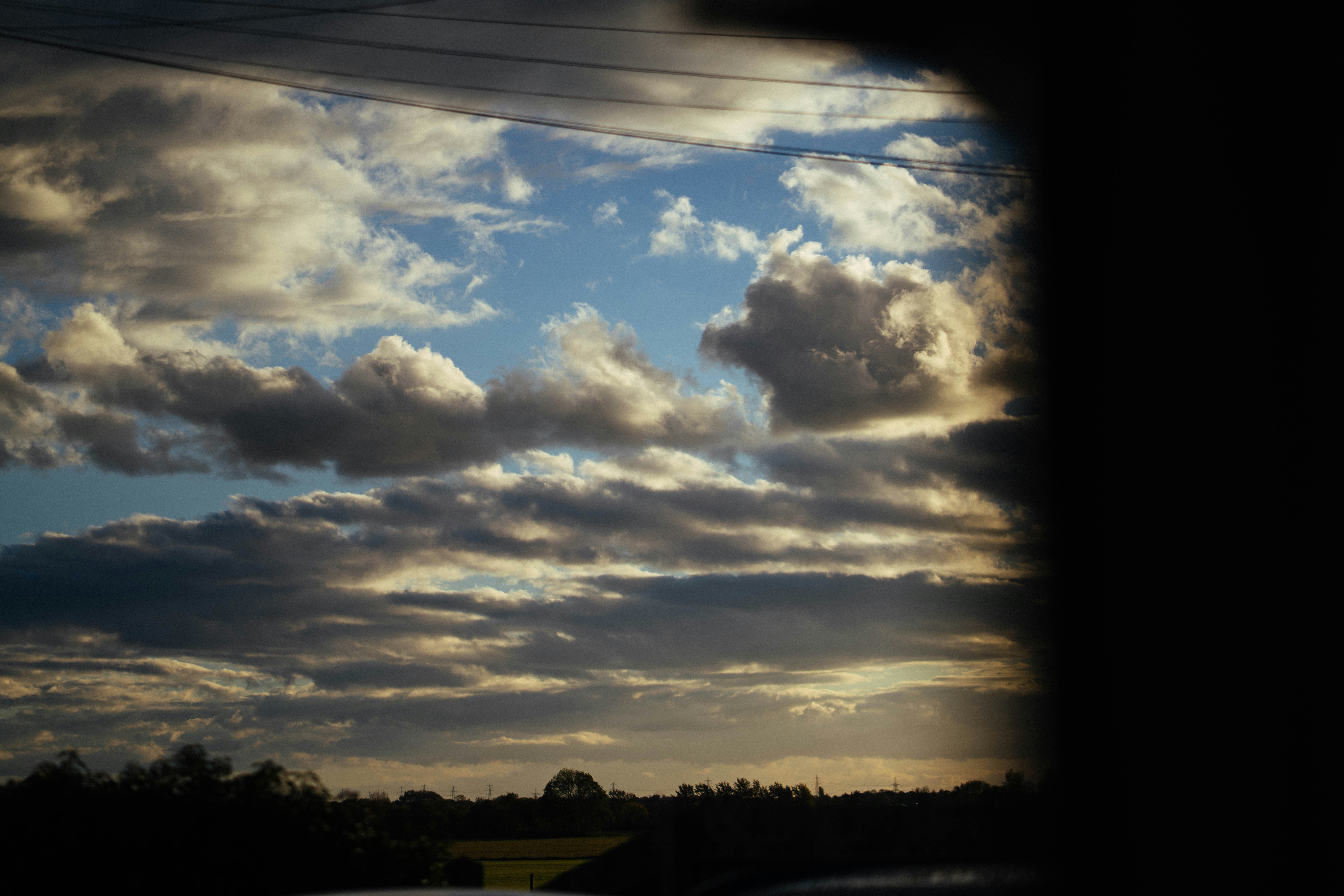 Dramatic clouds over a rural landscape at sunset