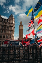 Big ben tower with flags flying in front