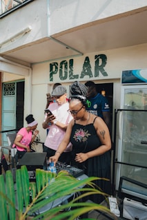 Woman djing at an outdoor event with people around