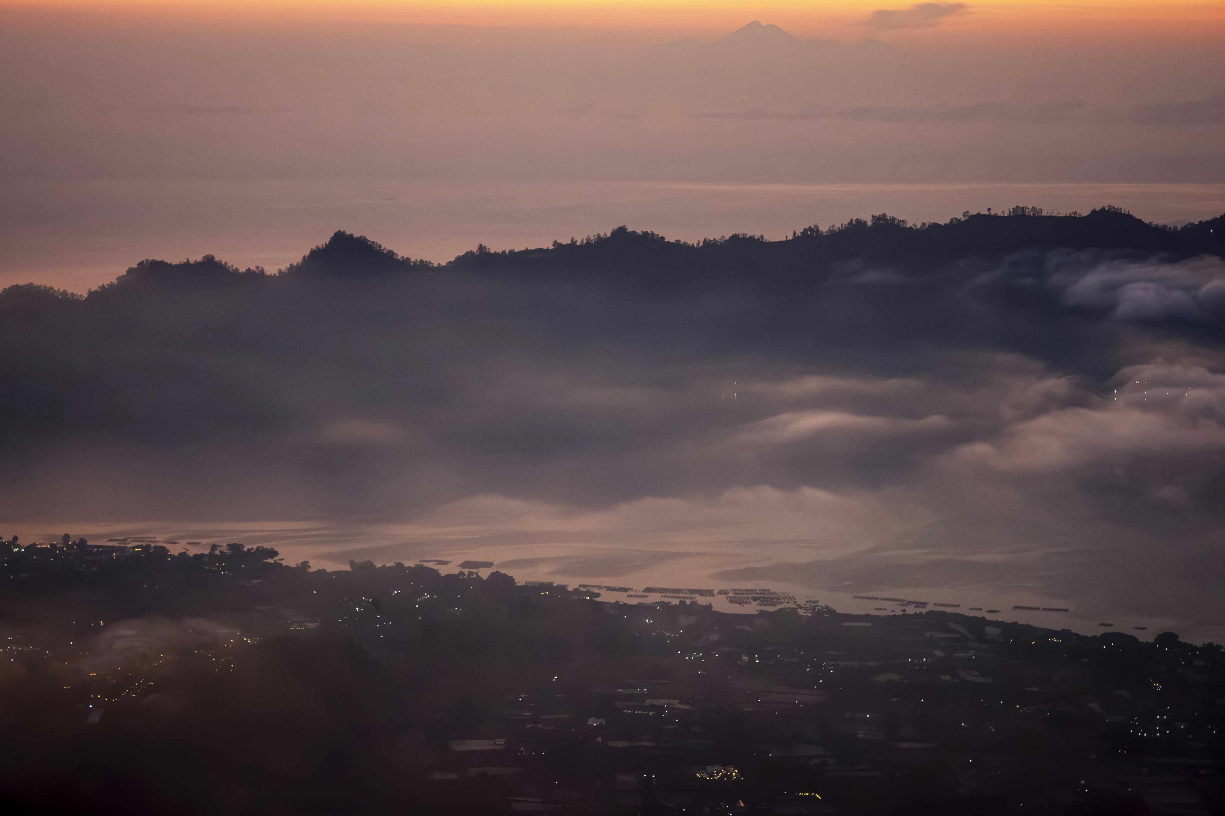 Mountain range shrouded in mist at sunrise