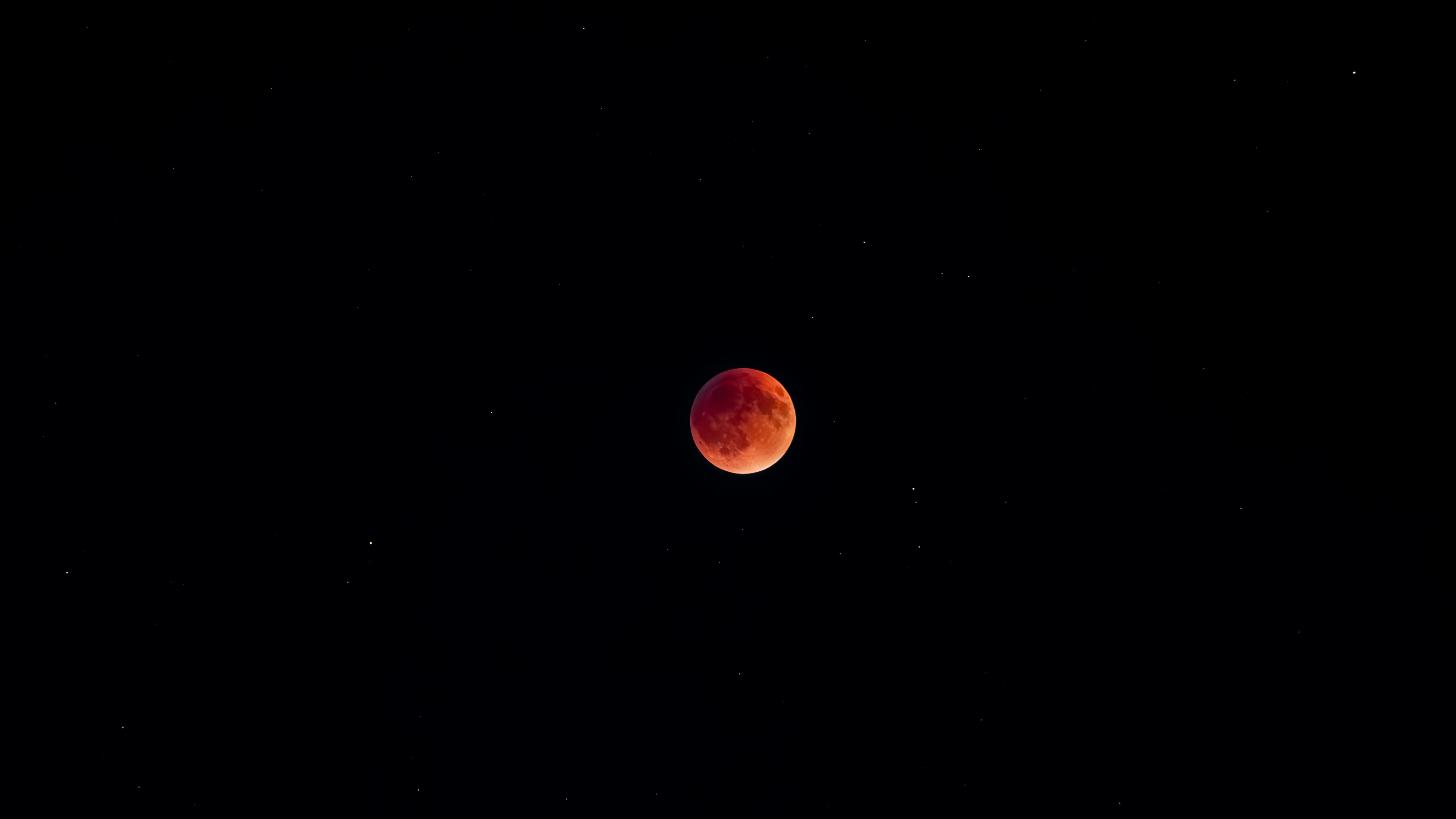Blood moon eclipse in the starry night sky