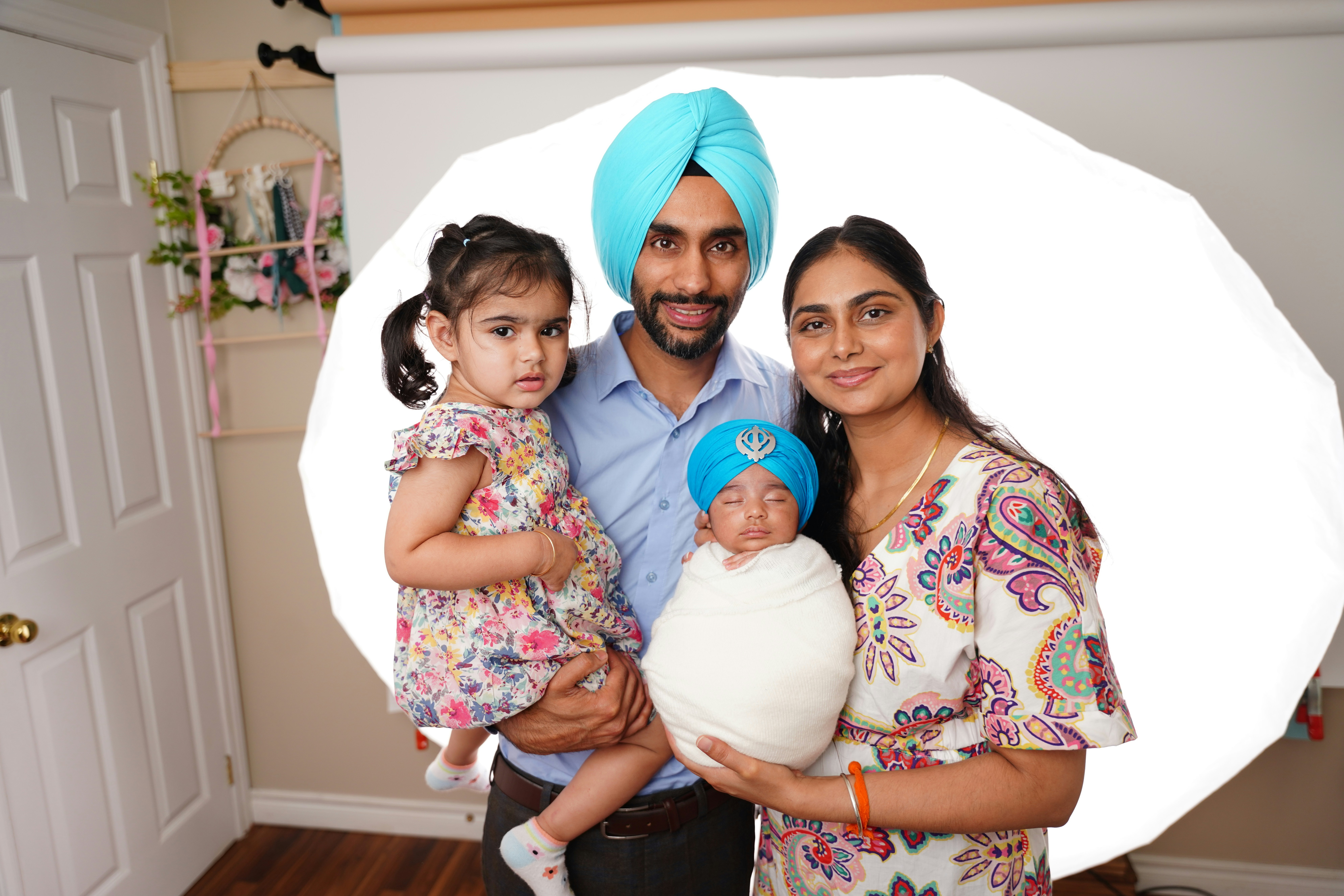 Family of four with a newborn baby and toddler.