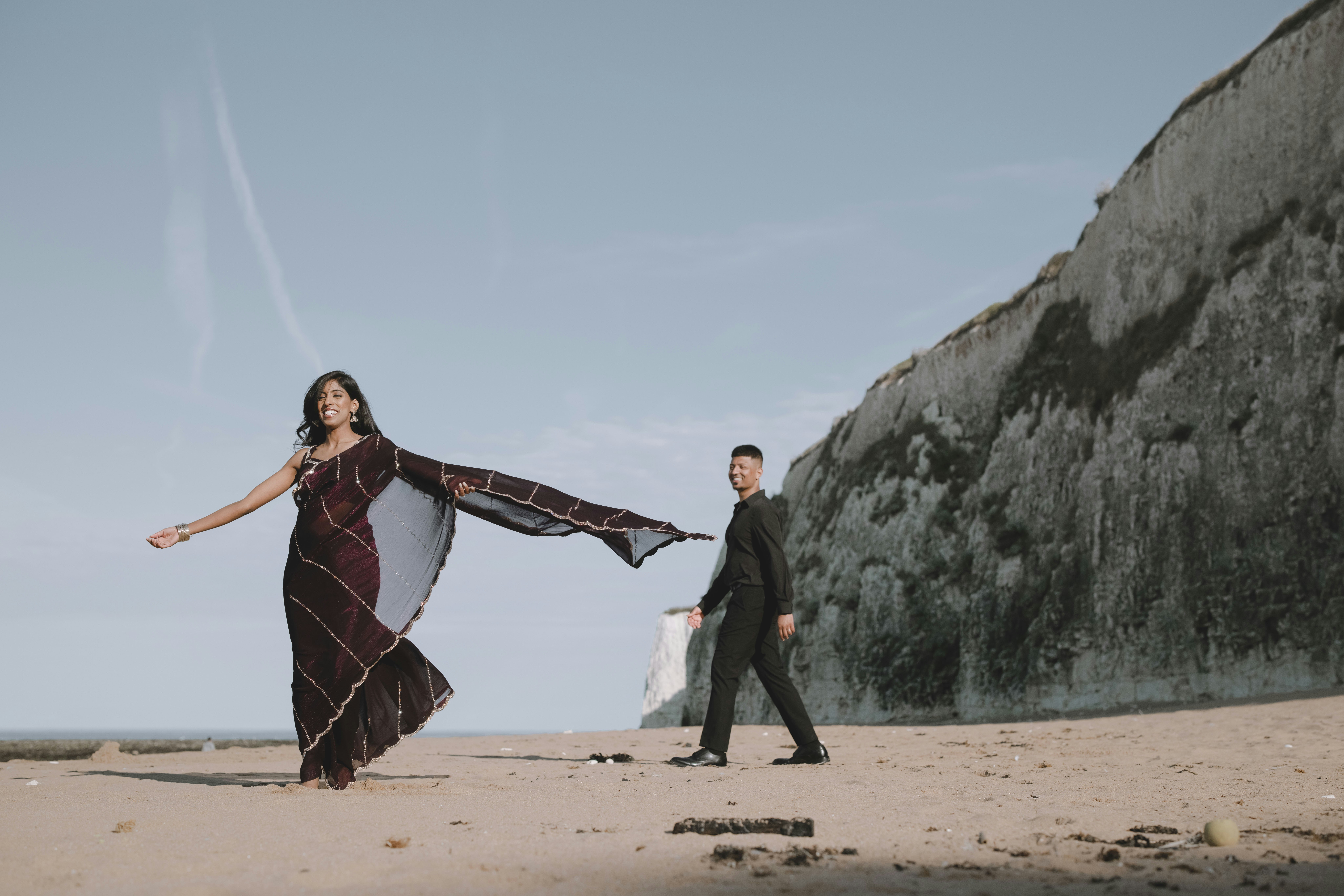Couple on a beach near a cliff