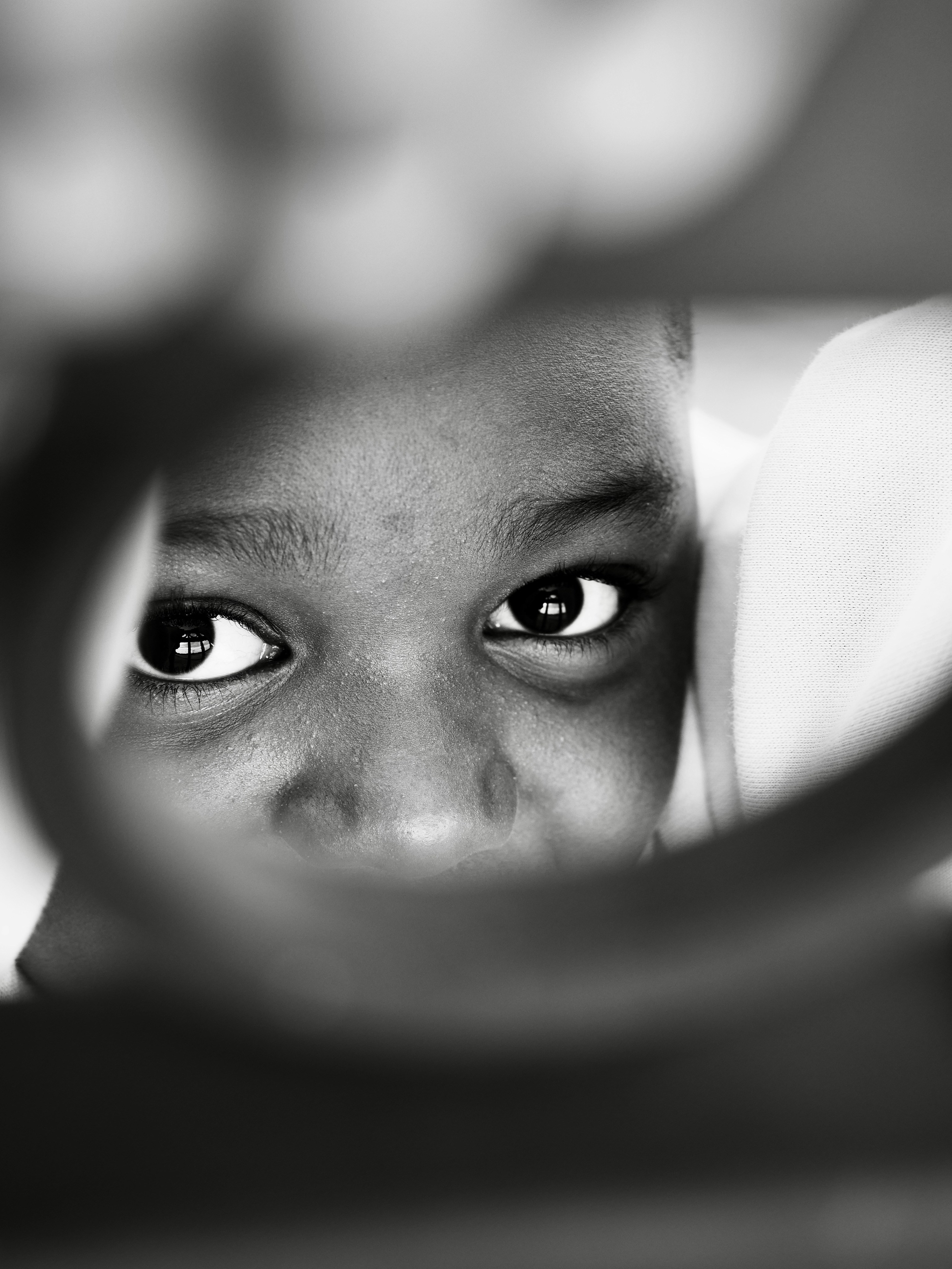 Close-up of a child's eyes looking through a circular frame