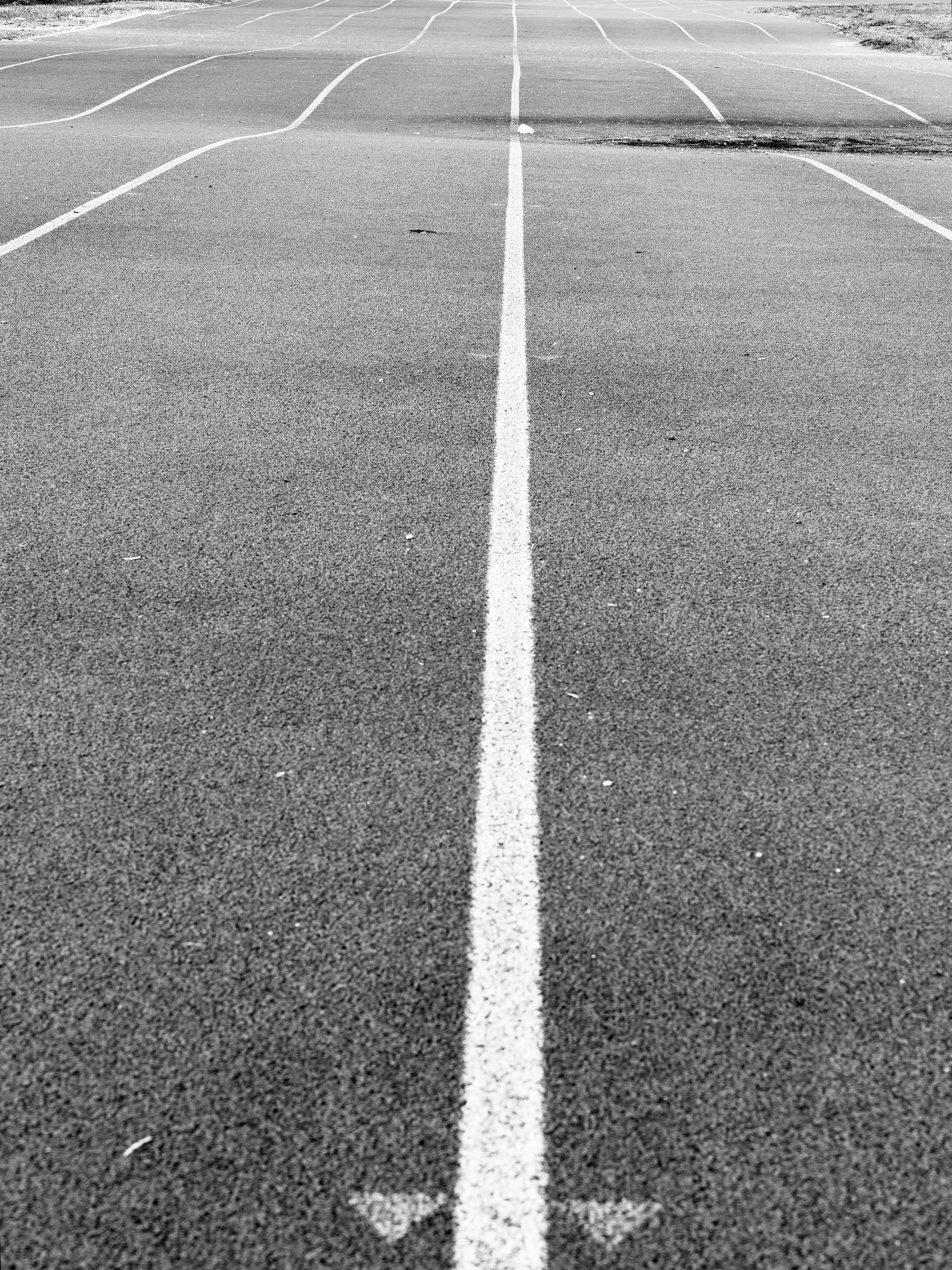 Running track with white lines fading into distance