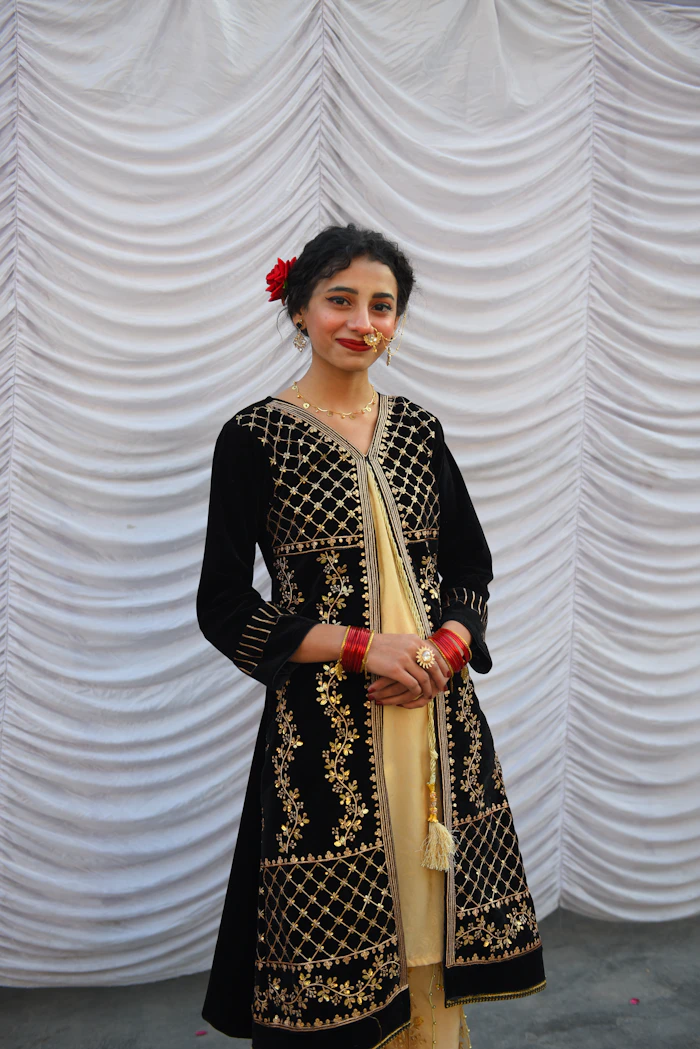 Illustrative stock portrait — Woman in black and gold embroidered outfit