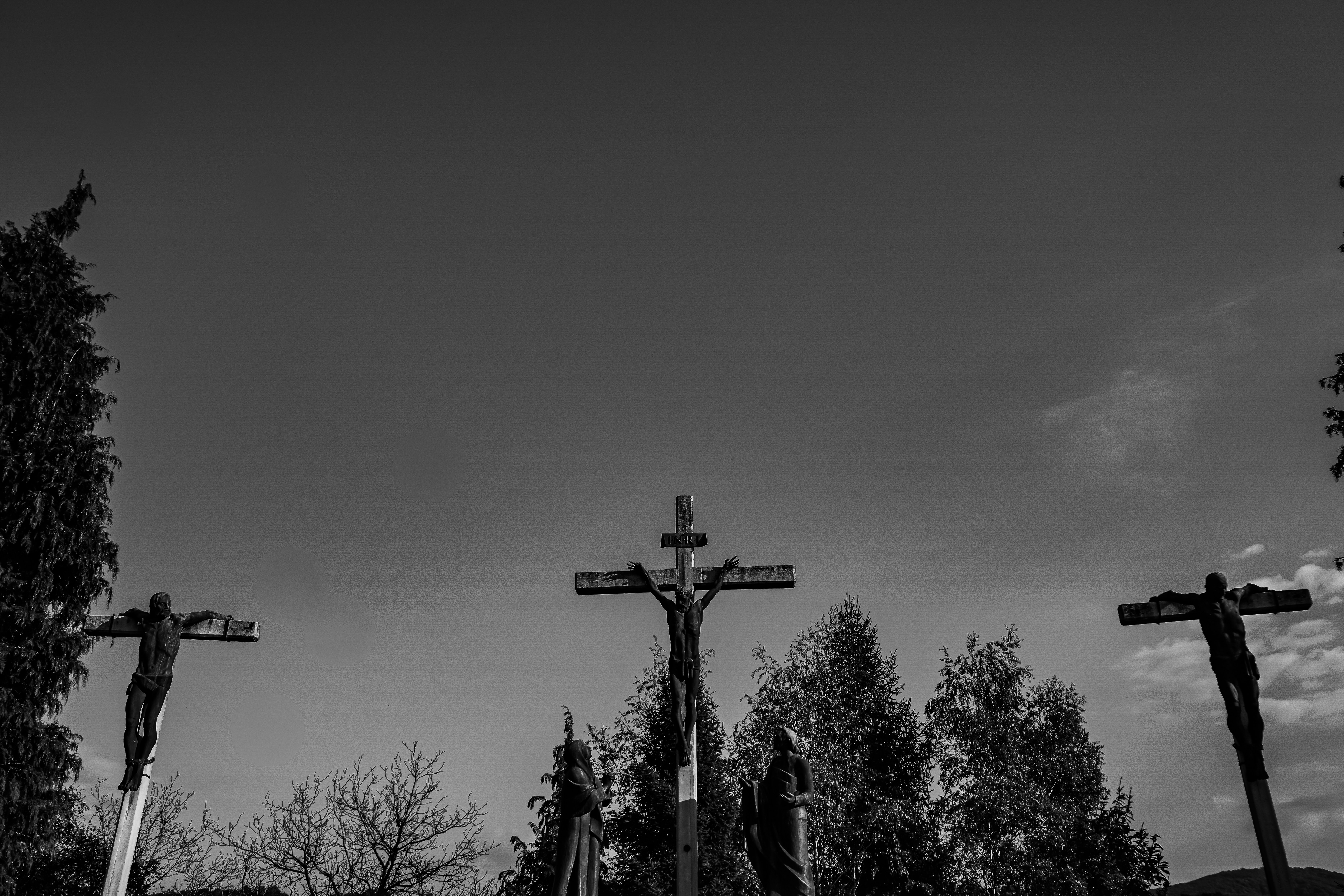 Three crucifixes against a cloudy sky