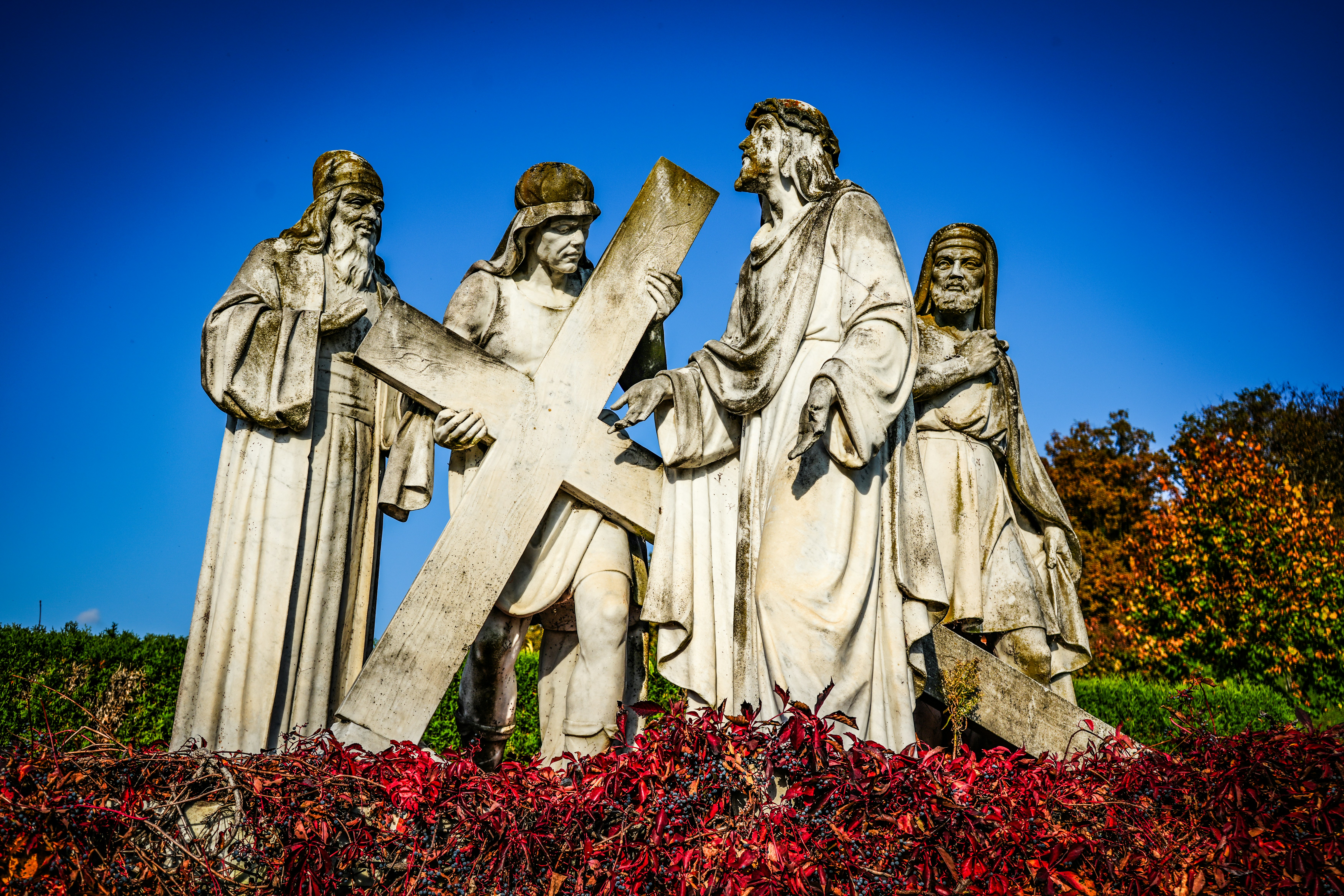 Stone statues of jesus carrying the cross