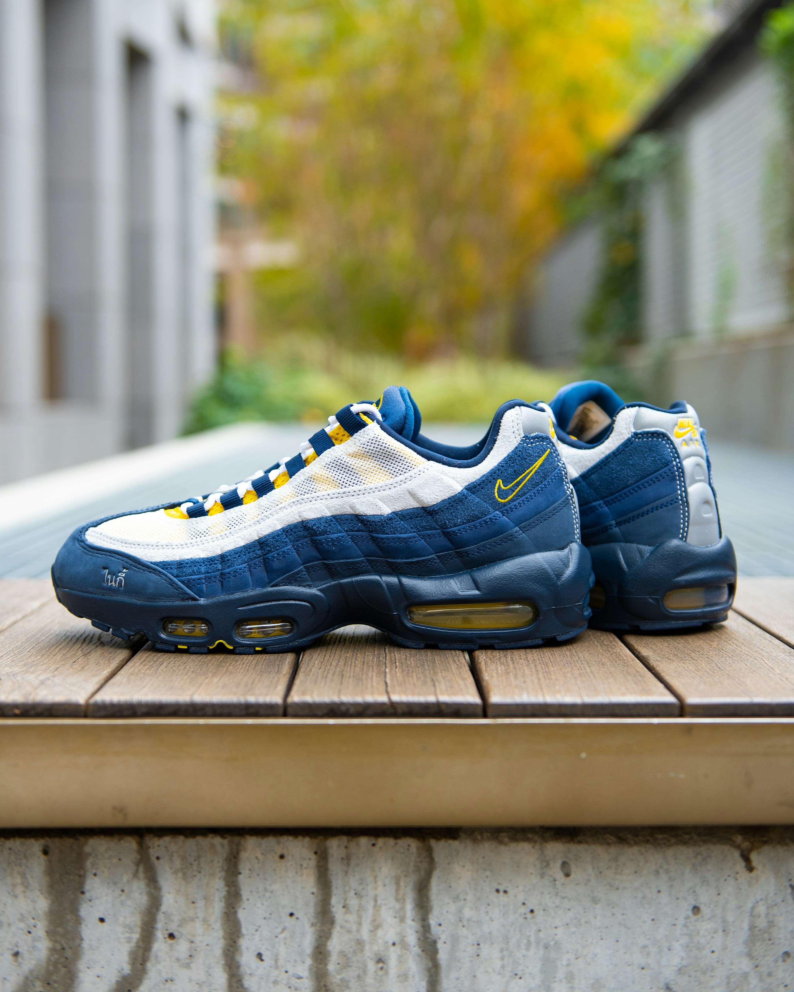Pair of blue and yellow nike air max sneakers.