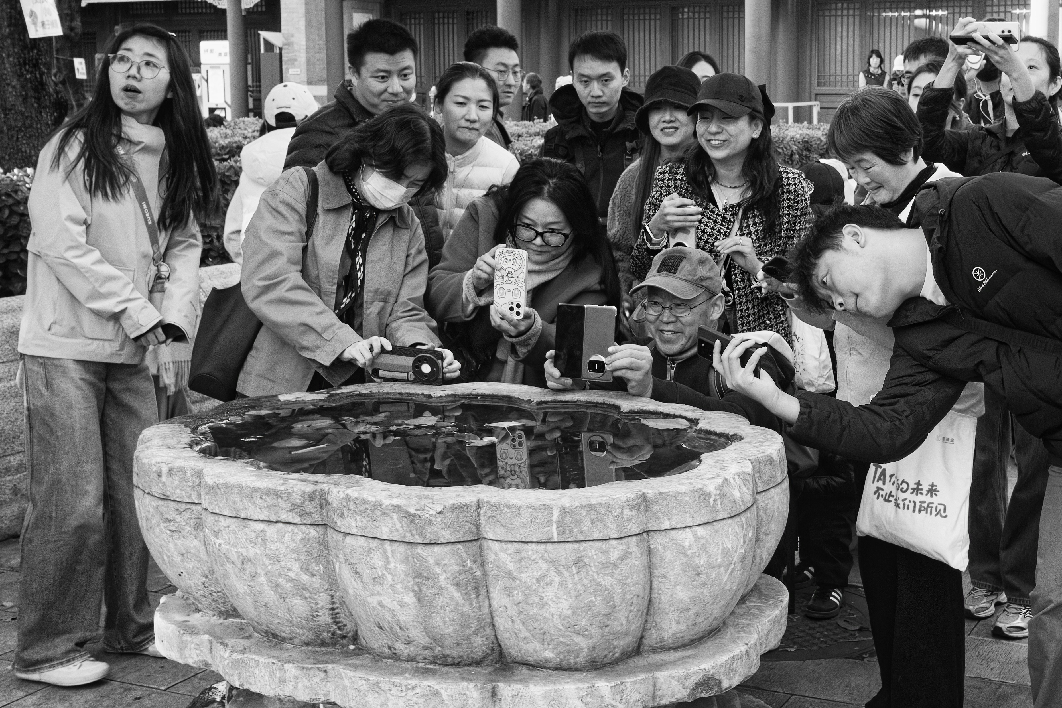 Group of people gathered around a miniature display.