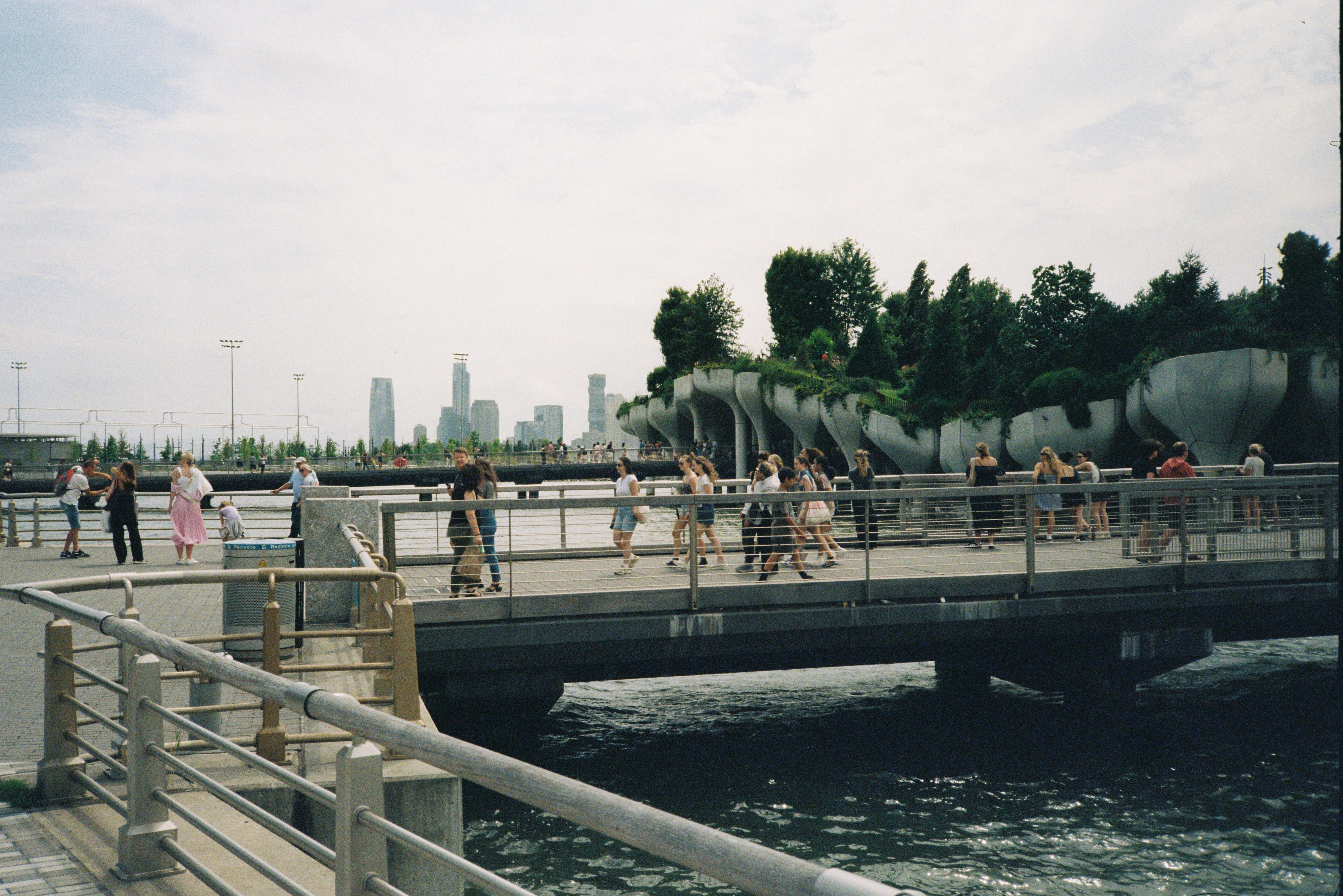 People walking on a pier with city skyline background