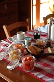Breakfast spread with fruit, yogurt, and bread.