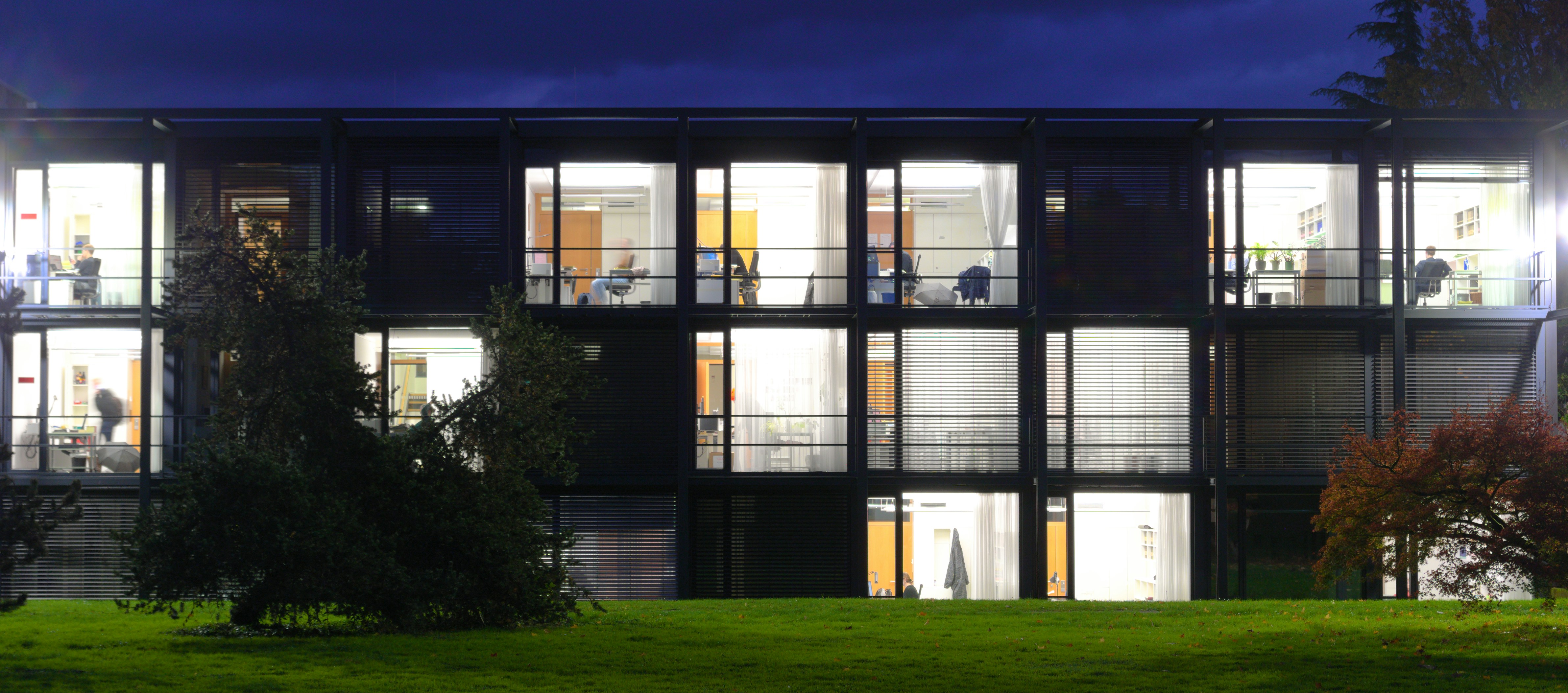 Modern building with illuminated windows at dusk