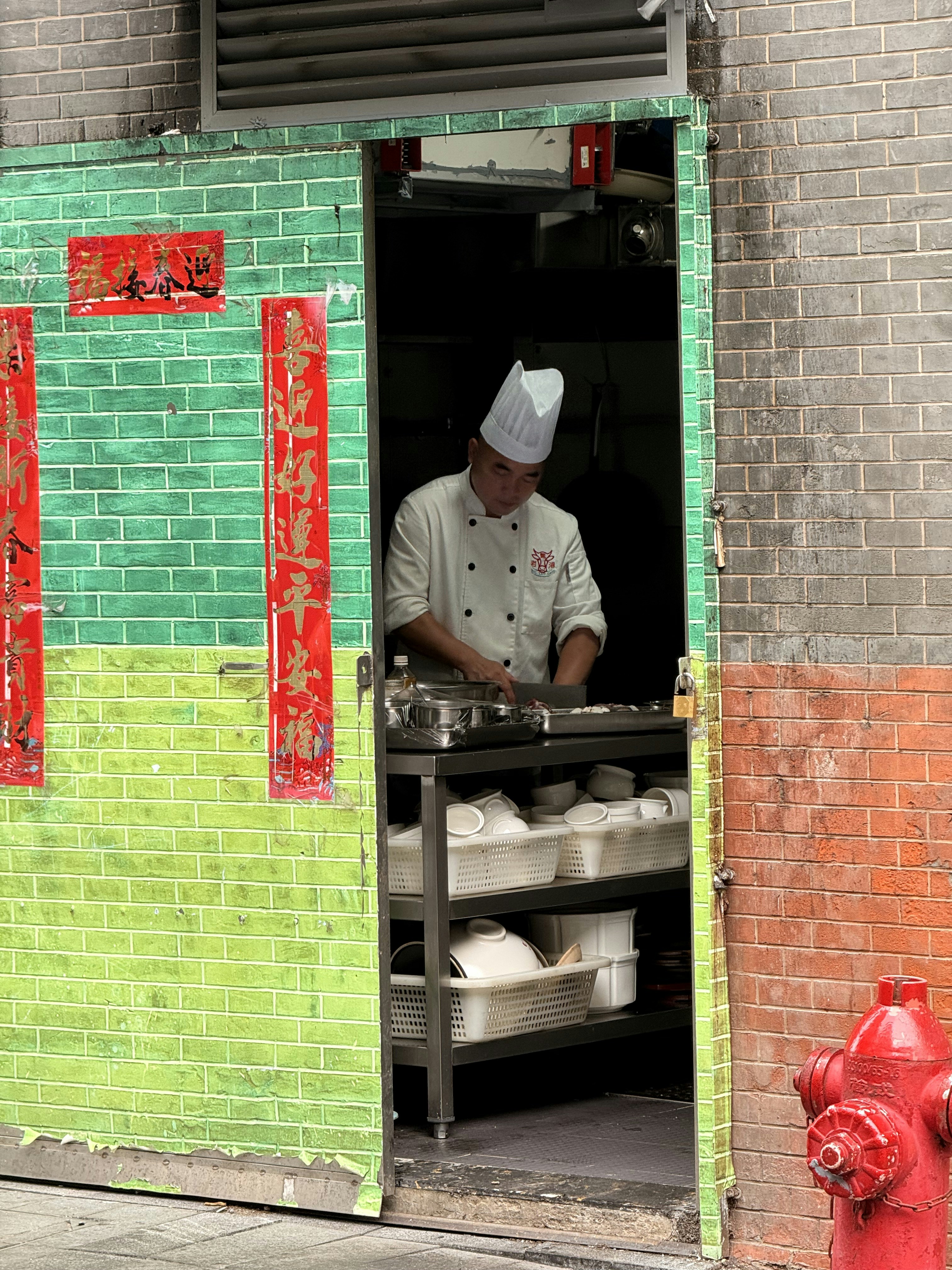 Chef preparing food in a doorway