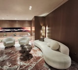Modern living room with curved sofa and marble floor