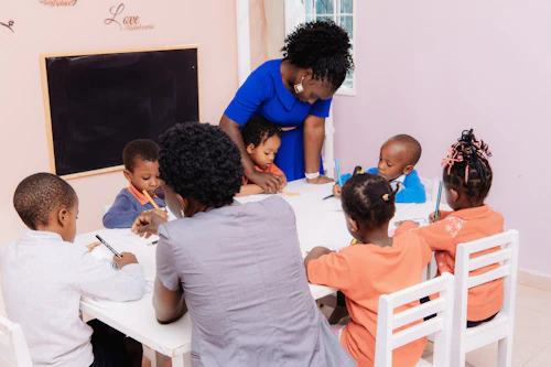 A therapist guiding children through a drawing activity