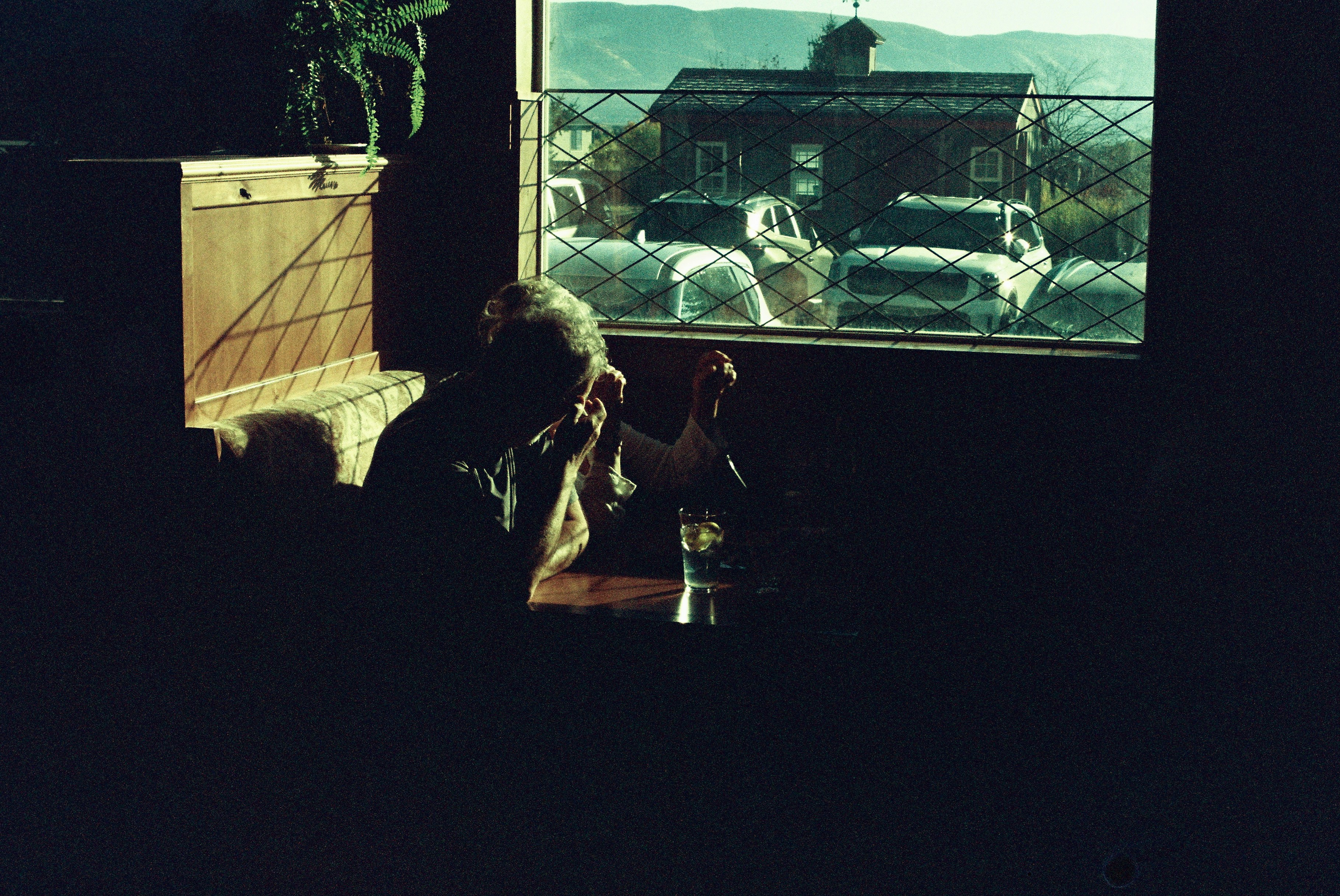 Man sitting by window with drink