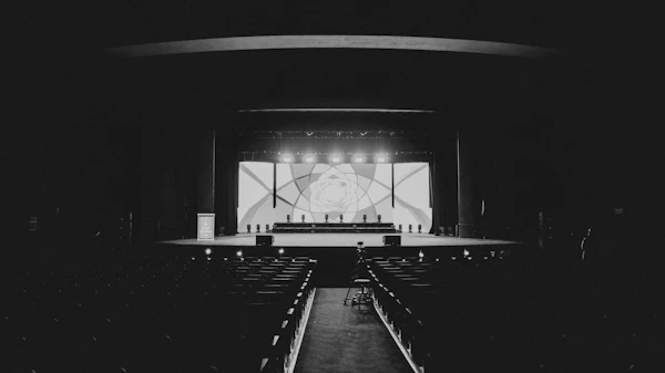 Chicago concert venue - A stage performance with audience in dark theater