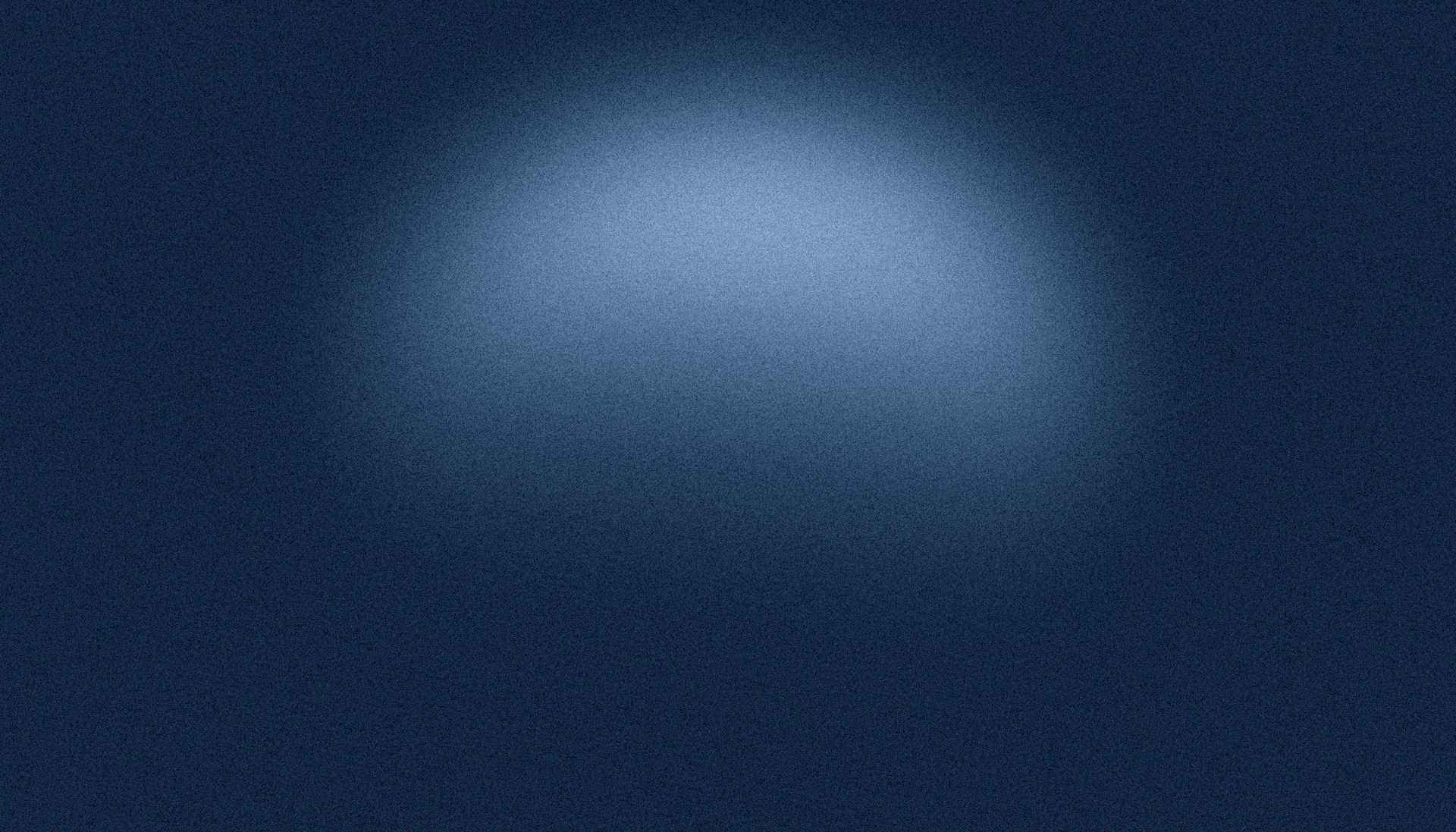 A dark blue background with a bright spotlight.