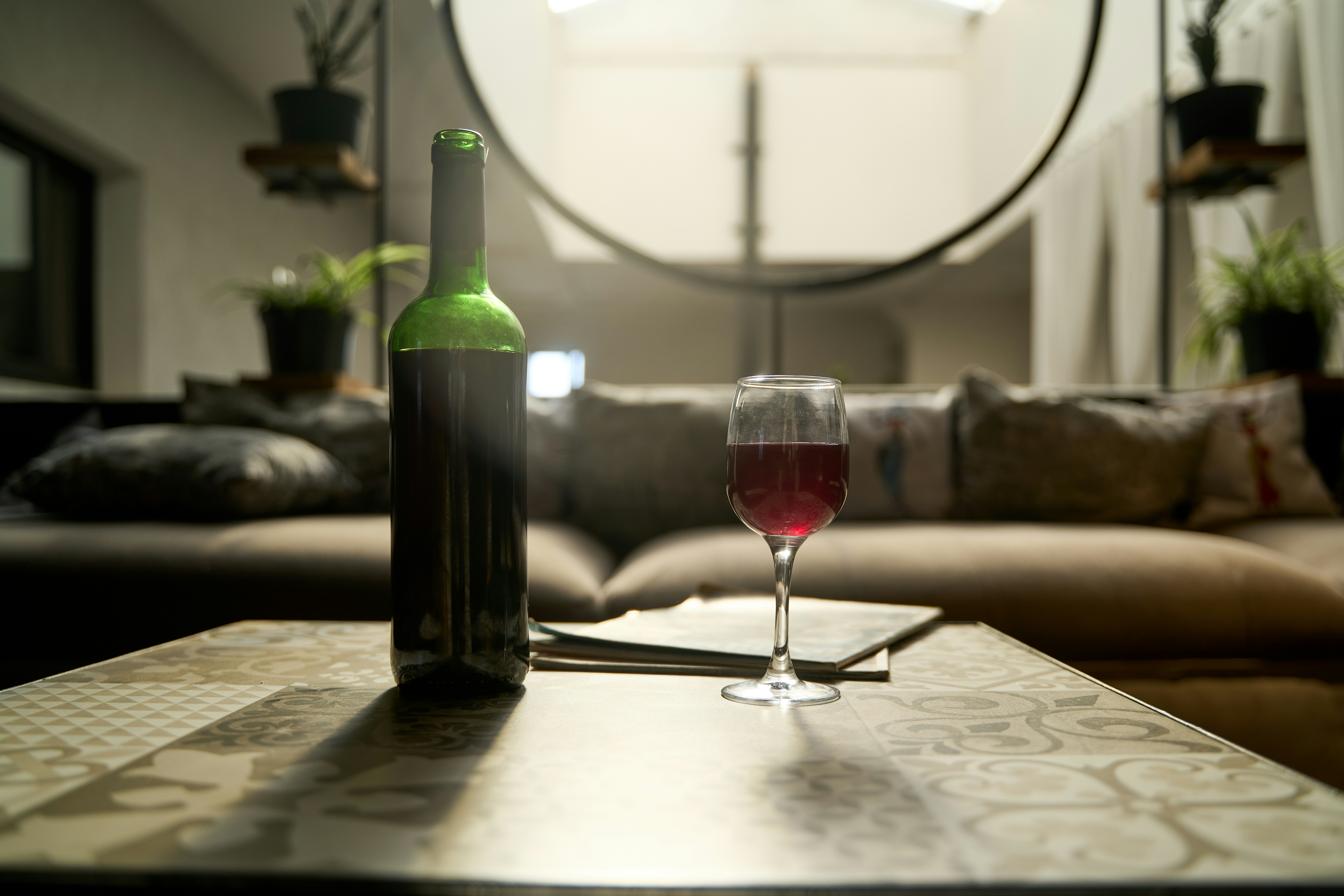 Bottle of wine and glass on table