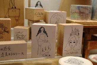 Wooden stamps with line drawings of women and text.