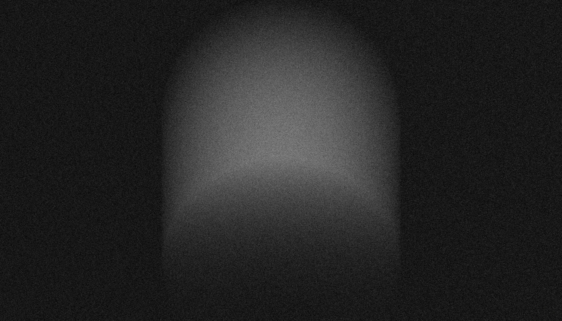 A dimly lit archway with a faint glow