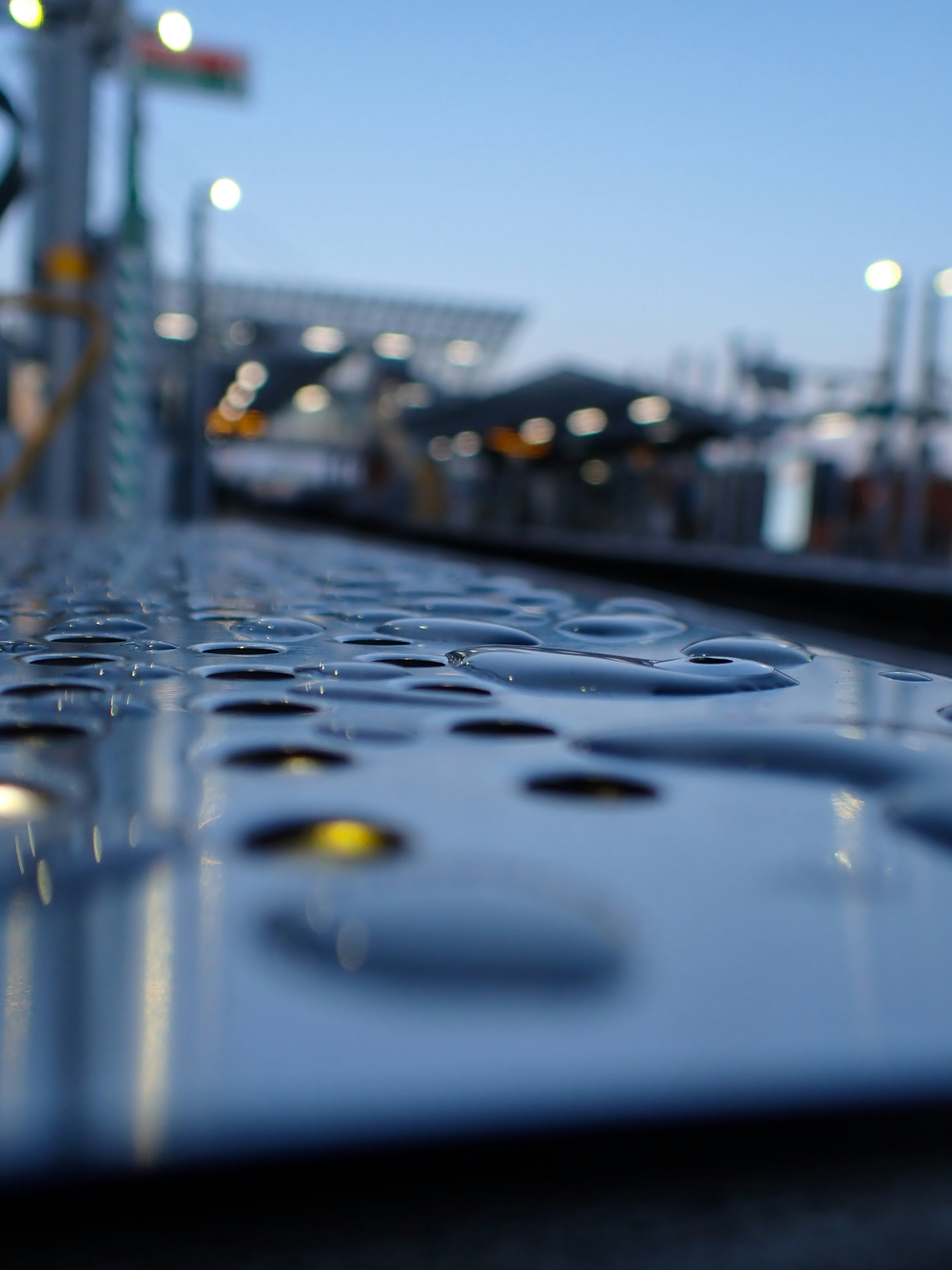 Water droplets on metal platform at train station