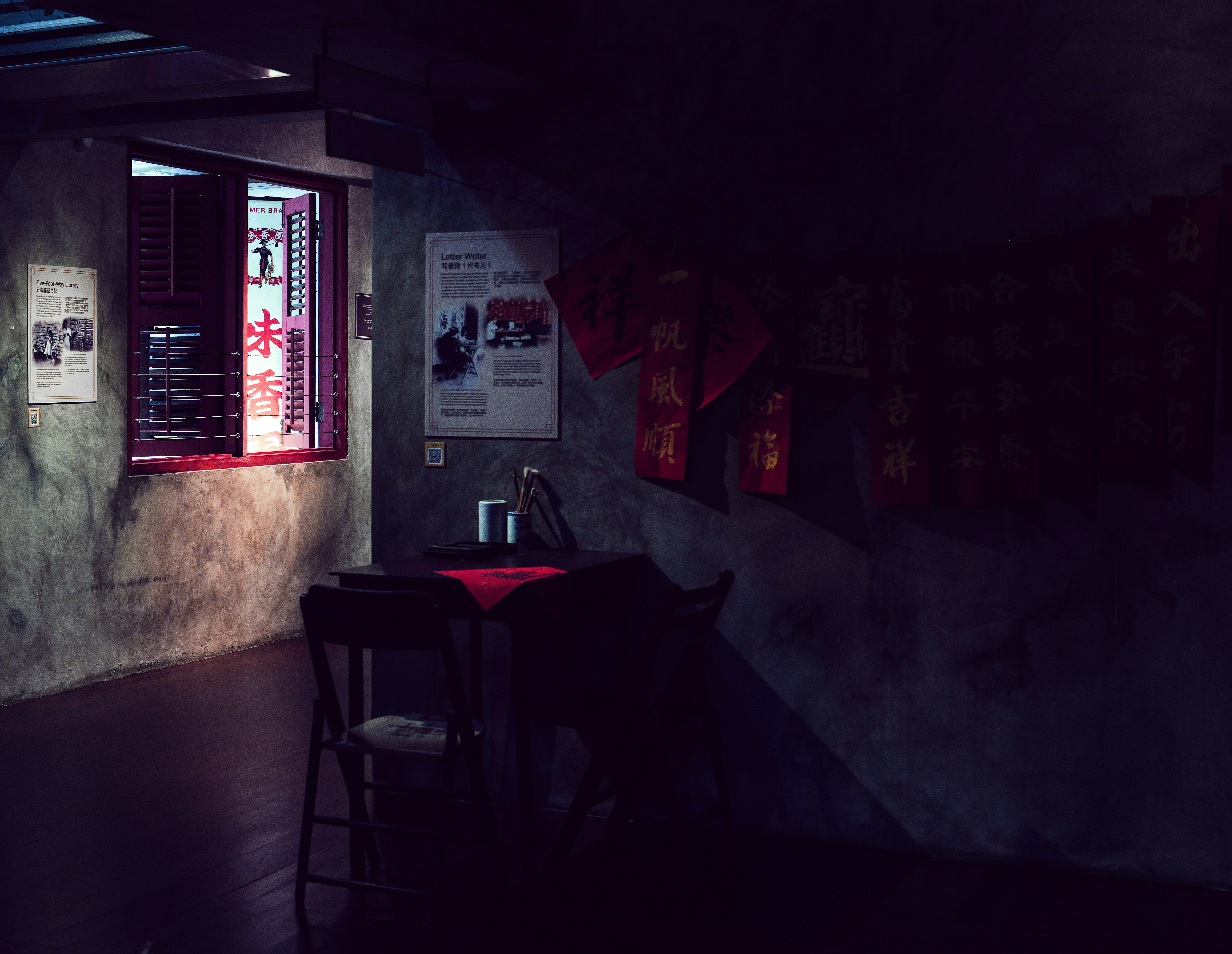 Dimly lit room with window and red decorations