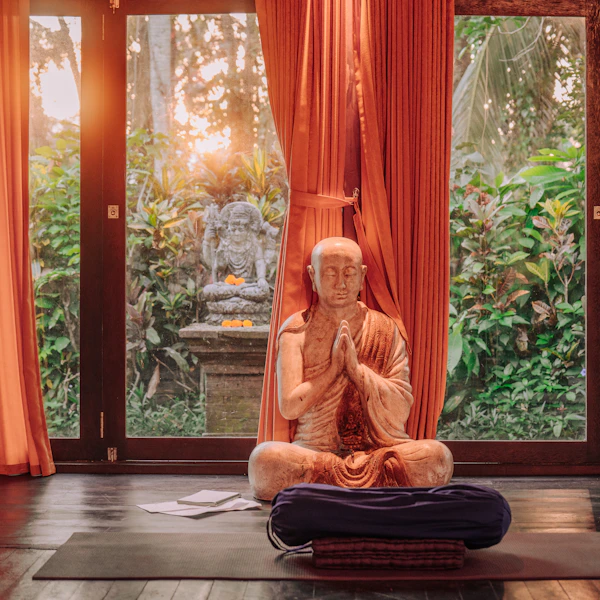 Buddhist statue meditating in a tranquil room