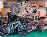 Multiple bicycles stored on shelves in a garage.