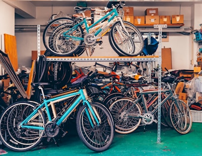 Multiple bicycles stored on shelves in a garage.
