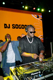 Dj playing music with a crowd watching