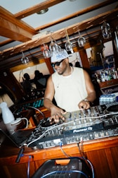 Dj playing music at a bar with turntables