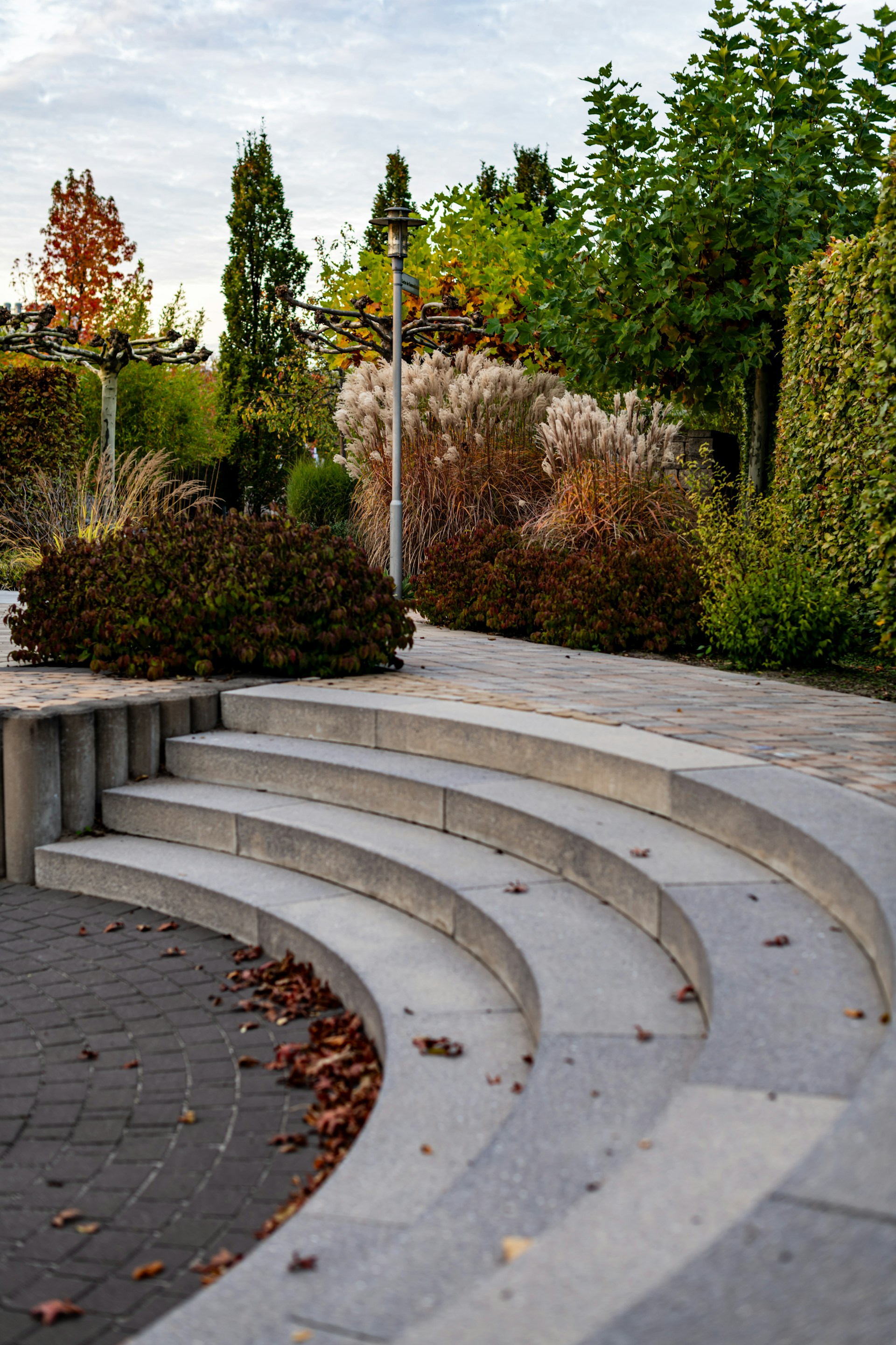 Curved stone steps lead to a lush garden