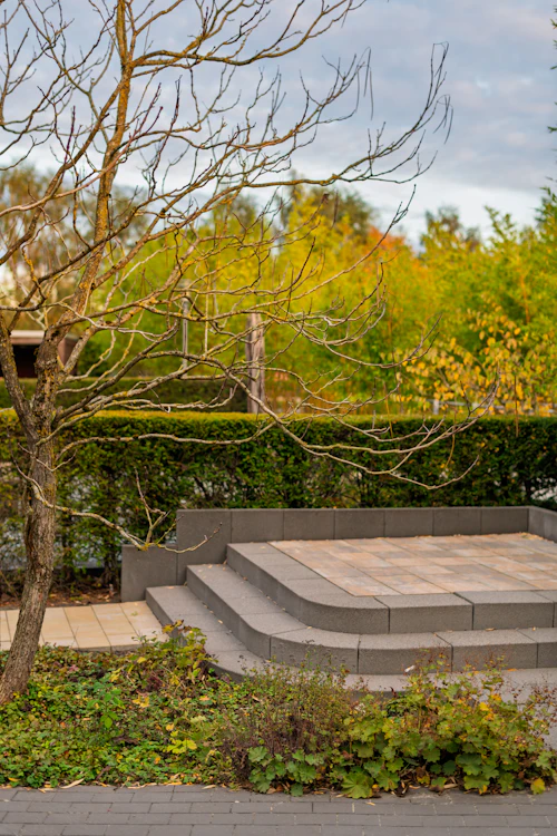 Curved stone steps leading to a paved patio