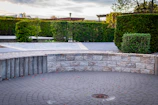 Curved stone wall surrounding a circular paved area