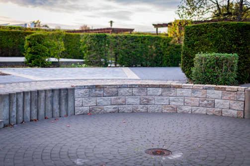 Curved stone wall surrounding a circular paved area